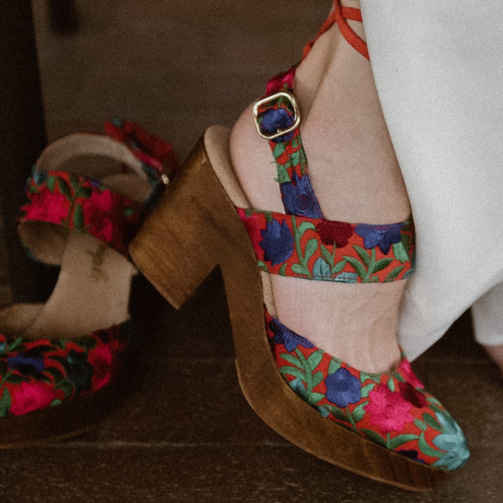 Details of colorful wedding shoes | Bride getting dressed | Santa Fe lesbian elopement photos at Inn of the Turquoise Bear in Santa Fe, New Mexico | Santa Fe lesbian elopement | Santa Fe elopement photographer | Santa Fe wedding | LGBTQ elopement | Photo by Denver Elopement Photographer Ashley Joyce Photography, copyright 2021