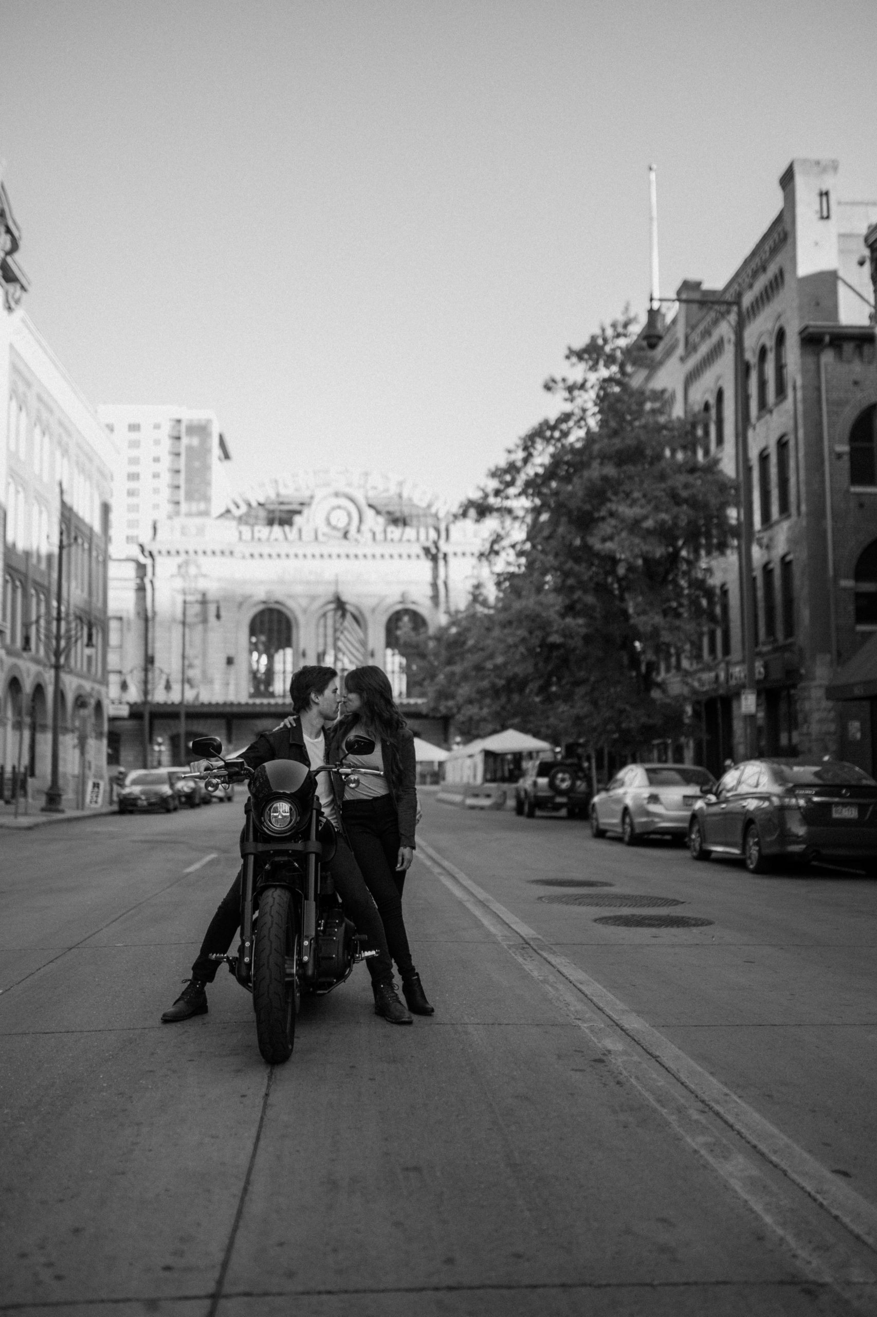 A Colorado engaged couple poses for their Downtown Denver Engagement session near Union Station. Photo by Denver elopement photographer, Ashley Joyce Photography, copyright 2022.