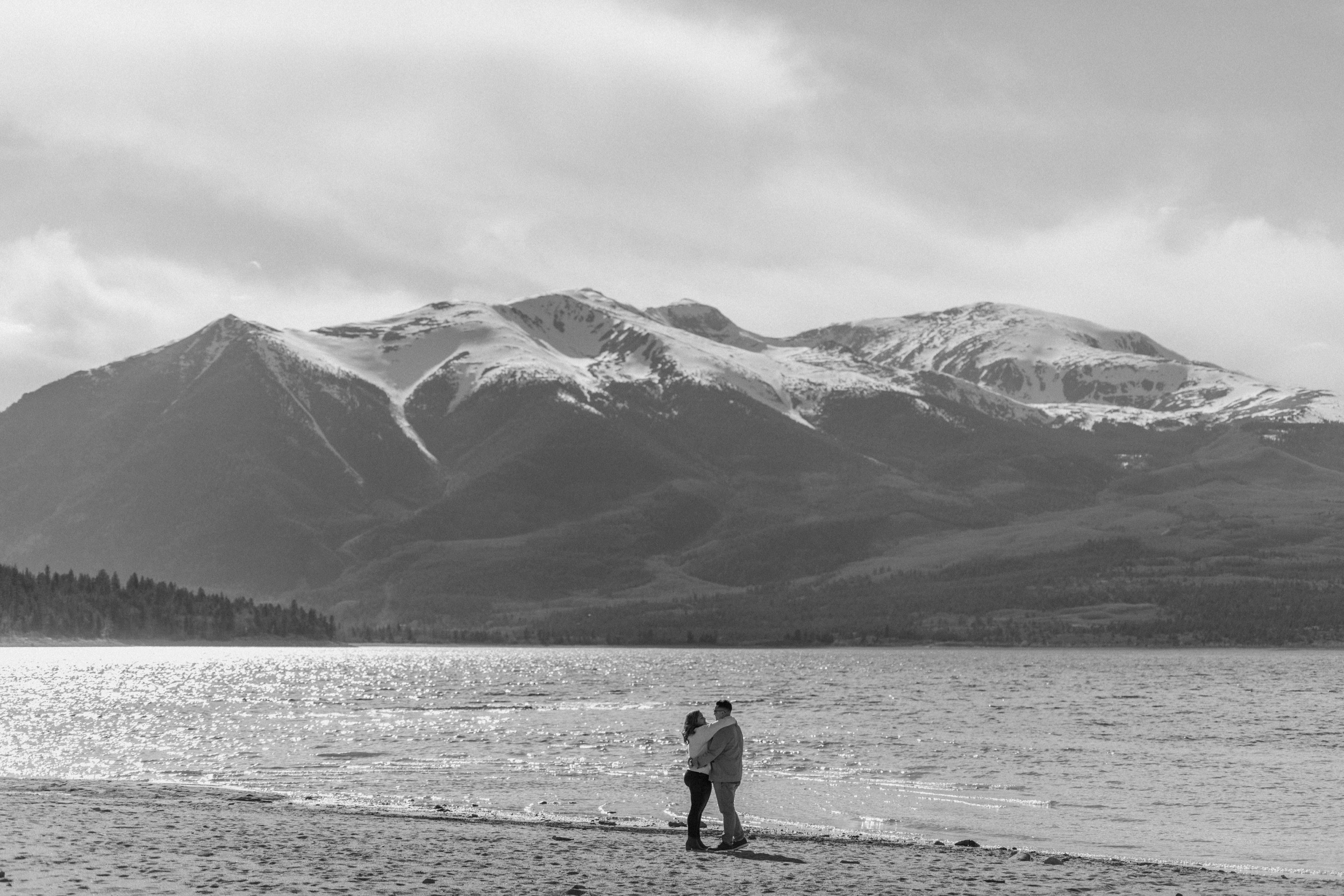 A couple poses for their Twin Lakes engagement photos at Twin Lakes, Colorado. Photo by Denver elopement photographer, Ashley Joyce Photography.