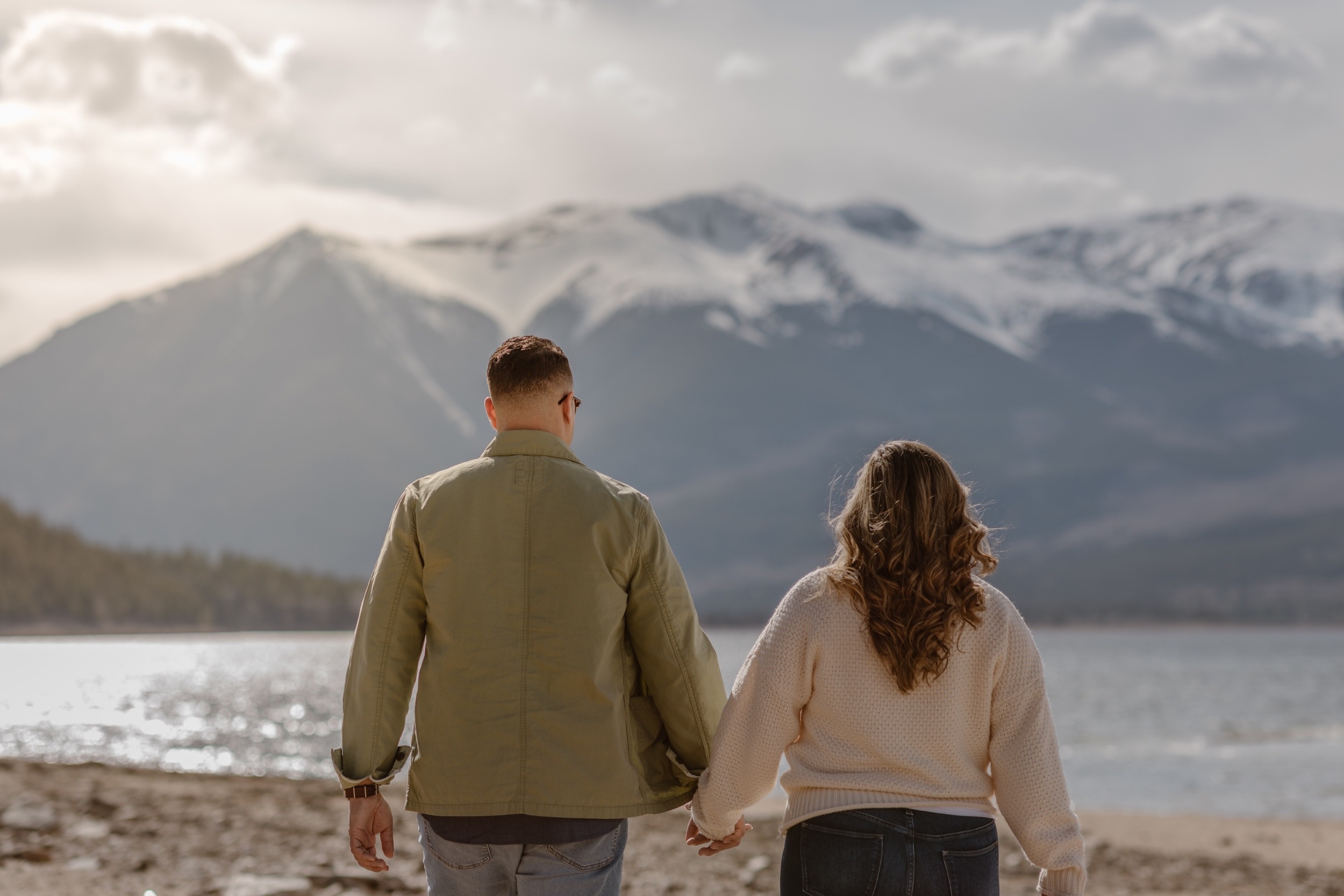 A couple poses for their Twin Lakes engagement photos at Twin Lakes, Colorado. Photo by Denver elopement photographer, Ashley Joyce Photography.