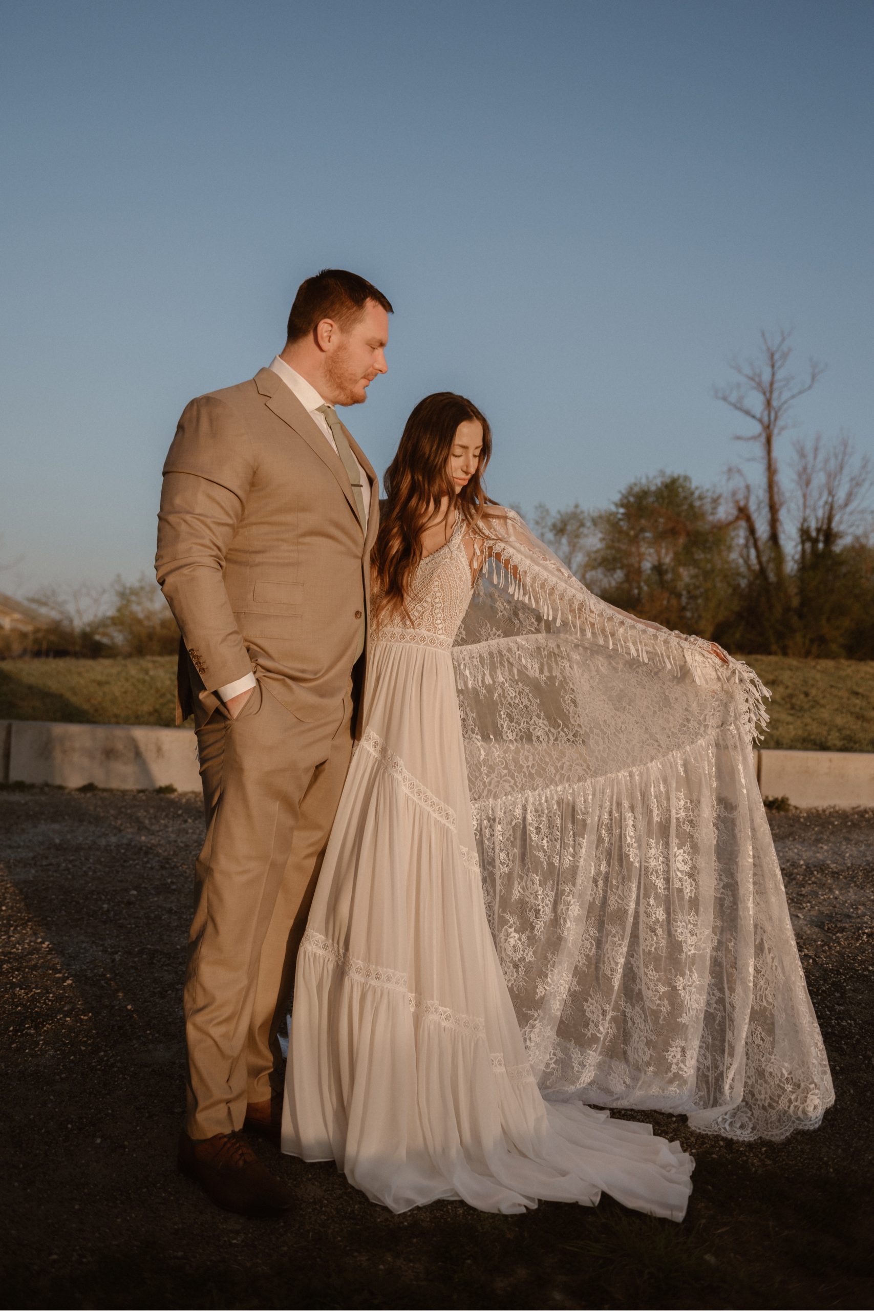 A married couple poses for their Alexandria, Virginia wedding anniversary photo session at Jones Point Park with Colorado photographer, Ashley Joyce Photography. Copyright Ashley Joyce Photography 2022.