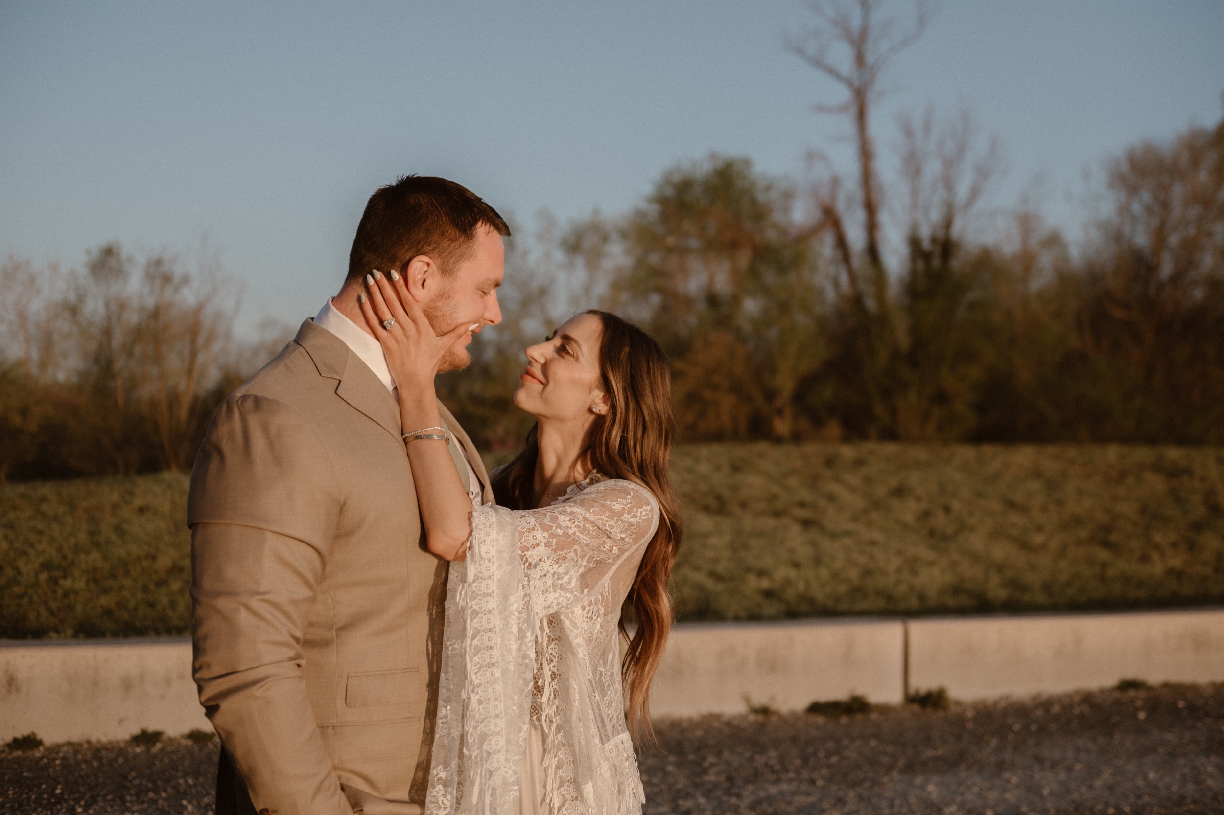 A married couple poses for their Alexandria, Virginia wedding anniversary photo session at Jones Point Park with Colorado photographer, Ashley Joyce Photography. Copyright Ashley Joyce Photography 2022.