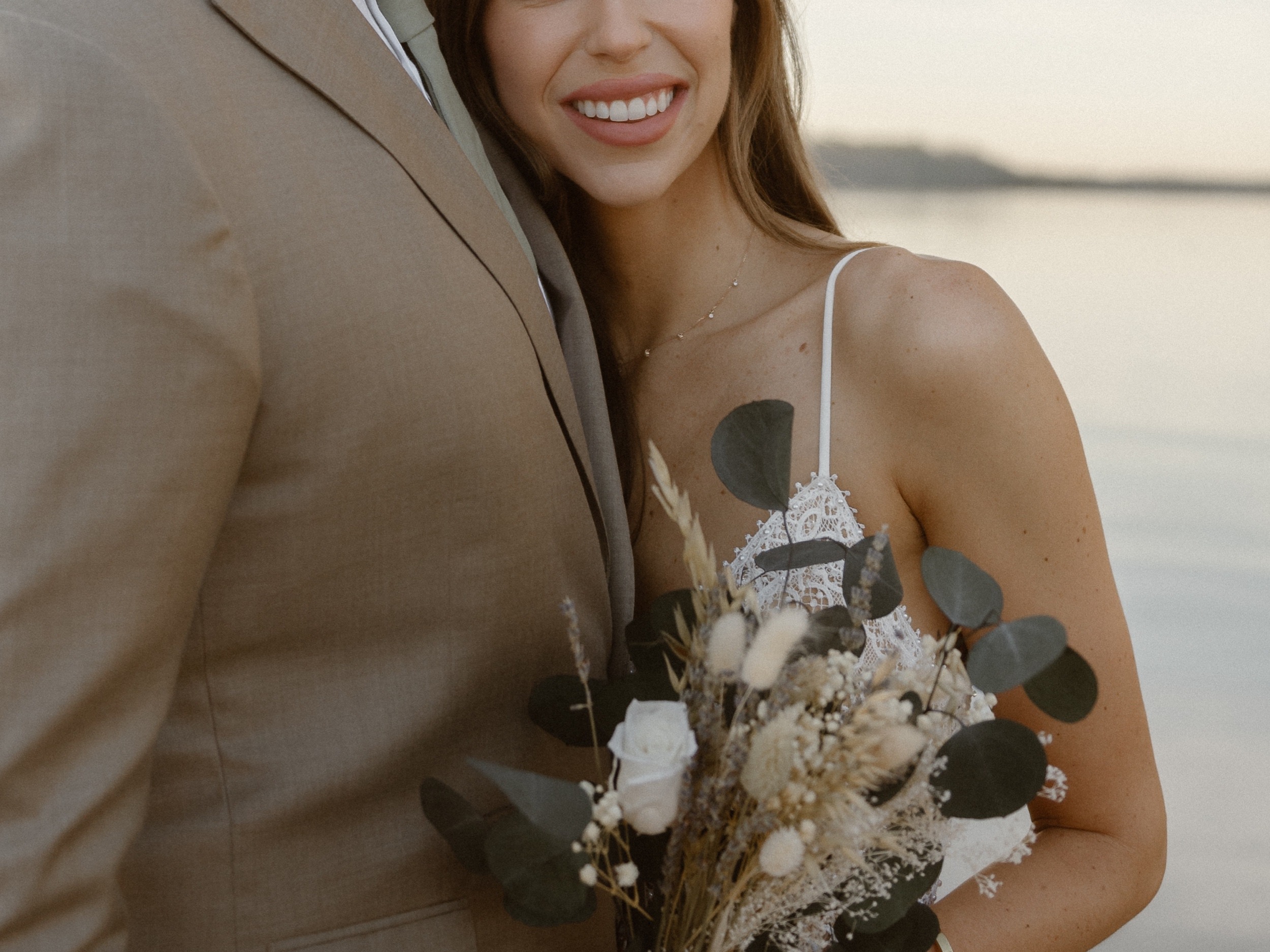 A married couple poses for their Alexandria, Virginia wedding anniversary photo session at Jones Point Park with Colorado photographer, Ashley Joyce Photography. Copyright Ashley Joyce Photography 2022.