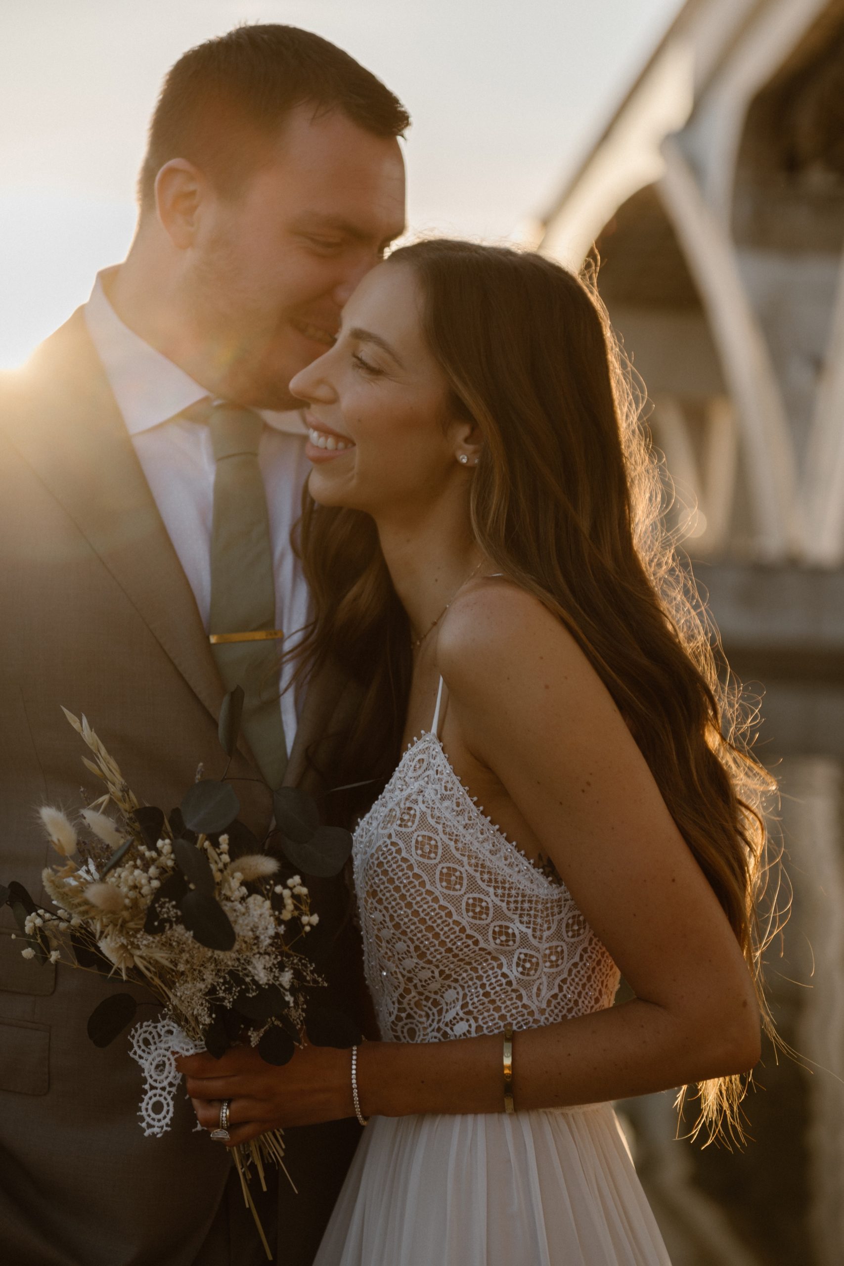 A married couple poses for their Alexandria, Virginia wedding anniversary photo session at Jones Point Park with Colorado photographer, Ashley Joyce Photography. Copyright Ashley Joyce Photography 2022.