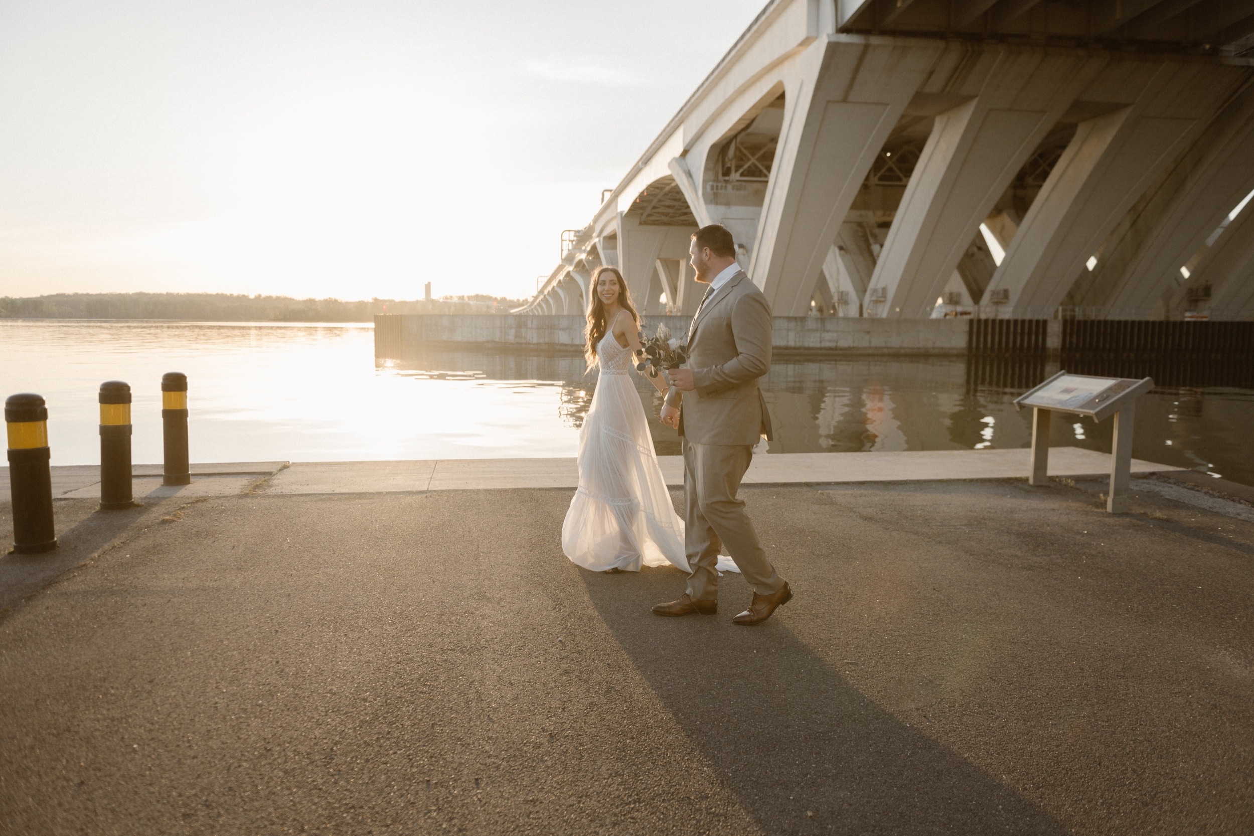 A married couple poses for their Alexandria, Virginia wedding anniversary photo session at Jones Point Park with Colorado photographer, Ashley Joyce Photography. Copyright Ashley Joyce Photography 2022.