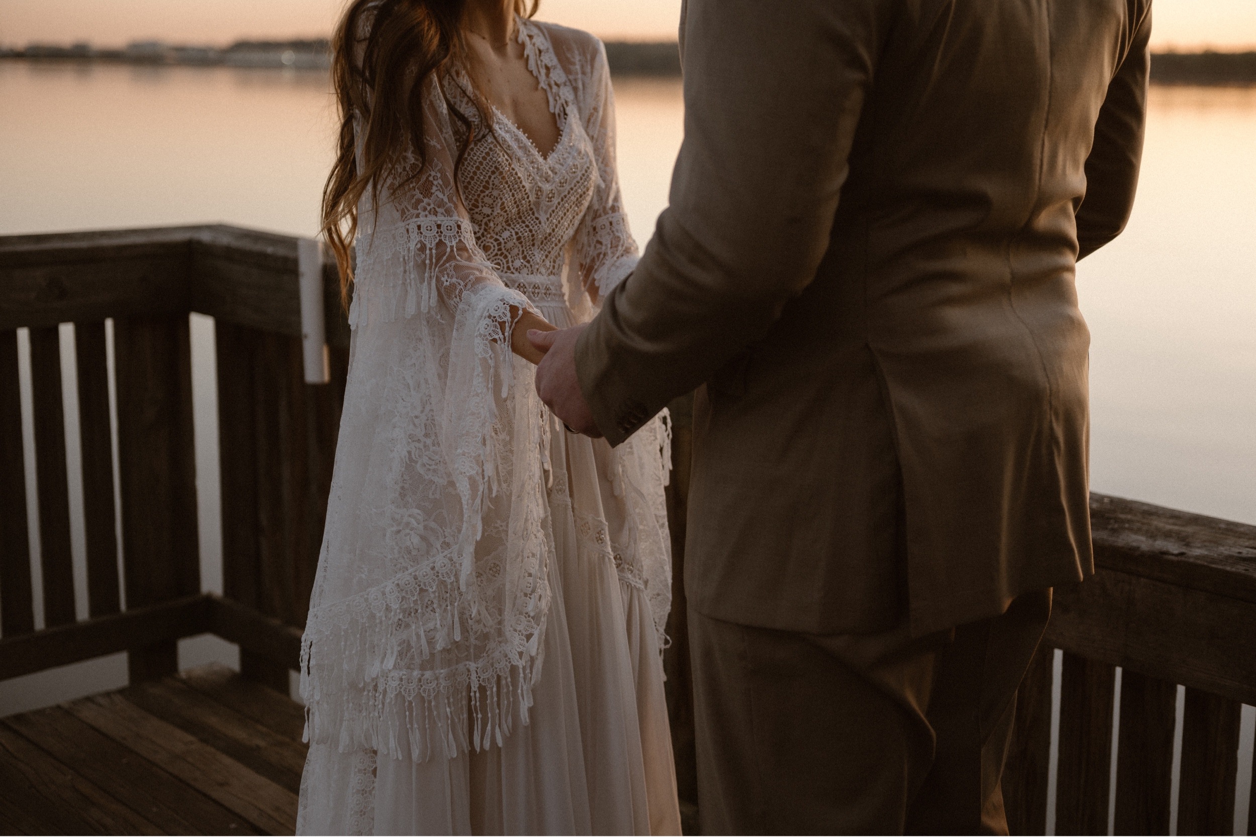 A married couple poses for their Alexandria, Virginia wedding anniversary photo session at Jones Point Park with Colorado photographer, Ashley Joyce Photography. Copyright Ashley Joyce Photography 2022.