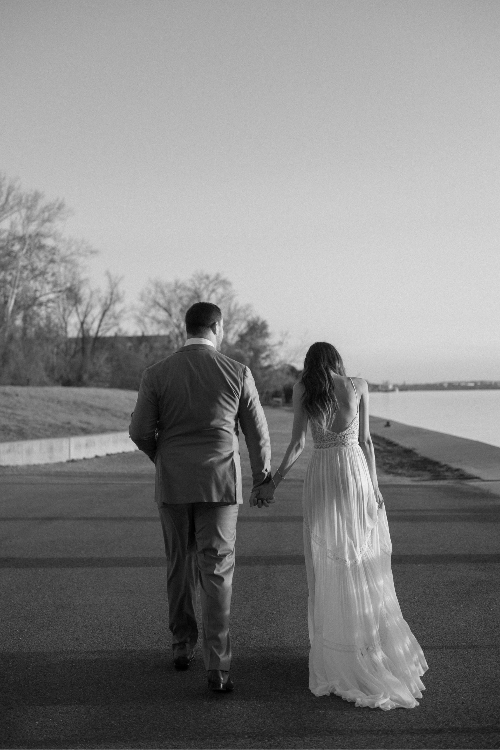 A married couple poses for their Alexandria, Virginia wedding anniversary photo session at Jones Point Park with Colorado photographer, Ashley Joyce Photography. Copyright Ashley Joyce Photography 2022.