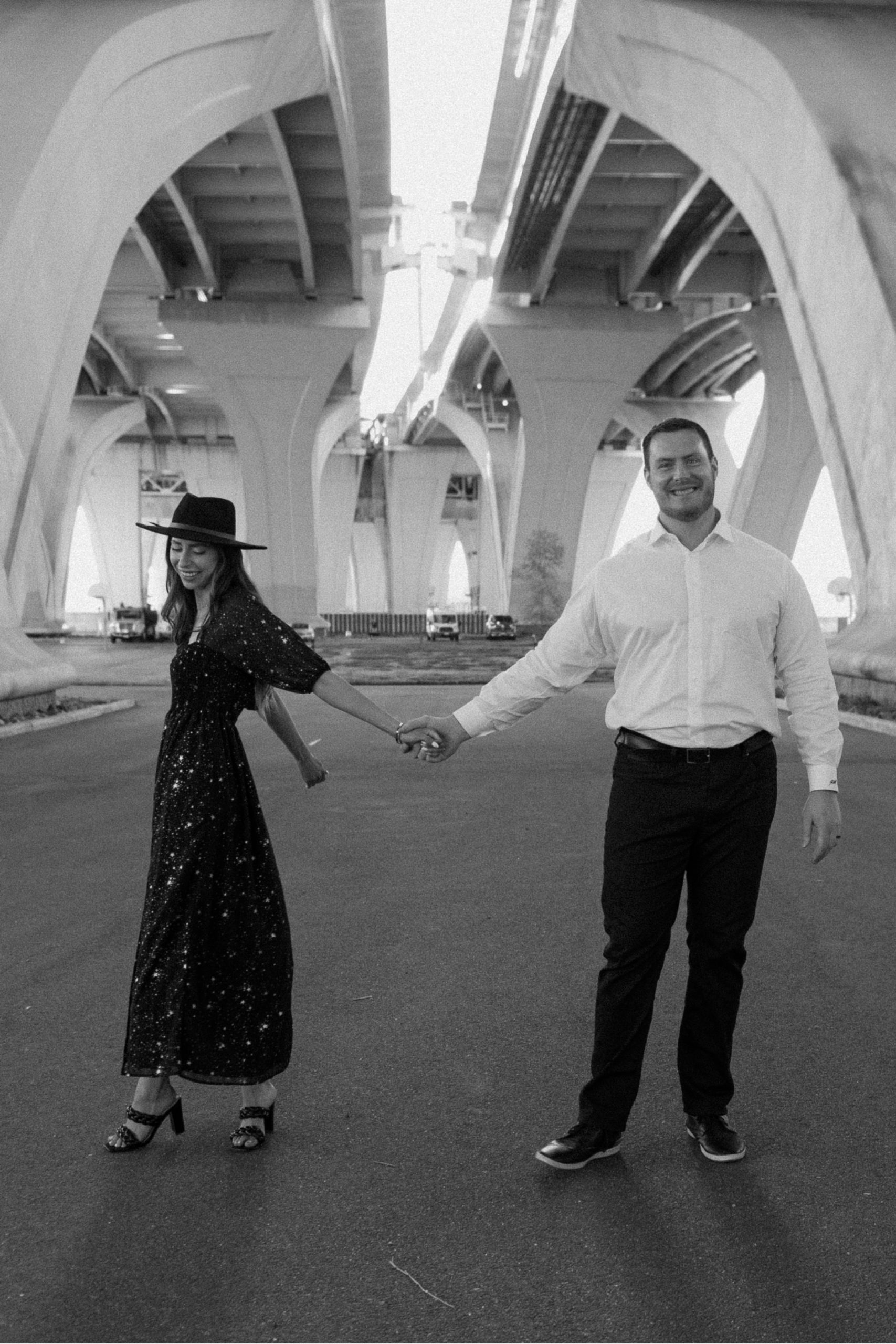 A married couple poses for their Alexandria, Virginia wedding anniversary photo session at Jones Point Park with Colorado photographer, Ashley Joyce Photography. Copyright Ashley Joyce Photography 2022.