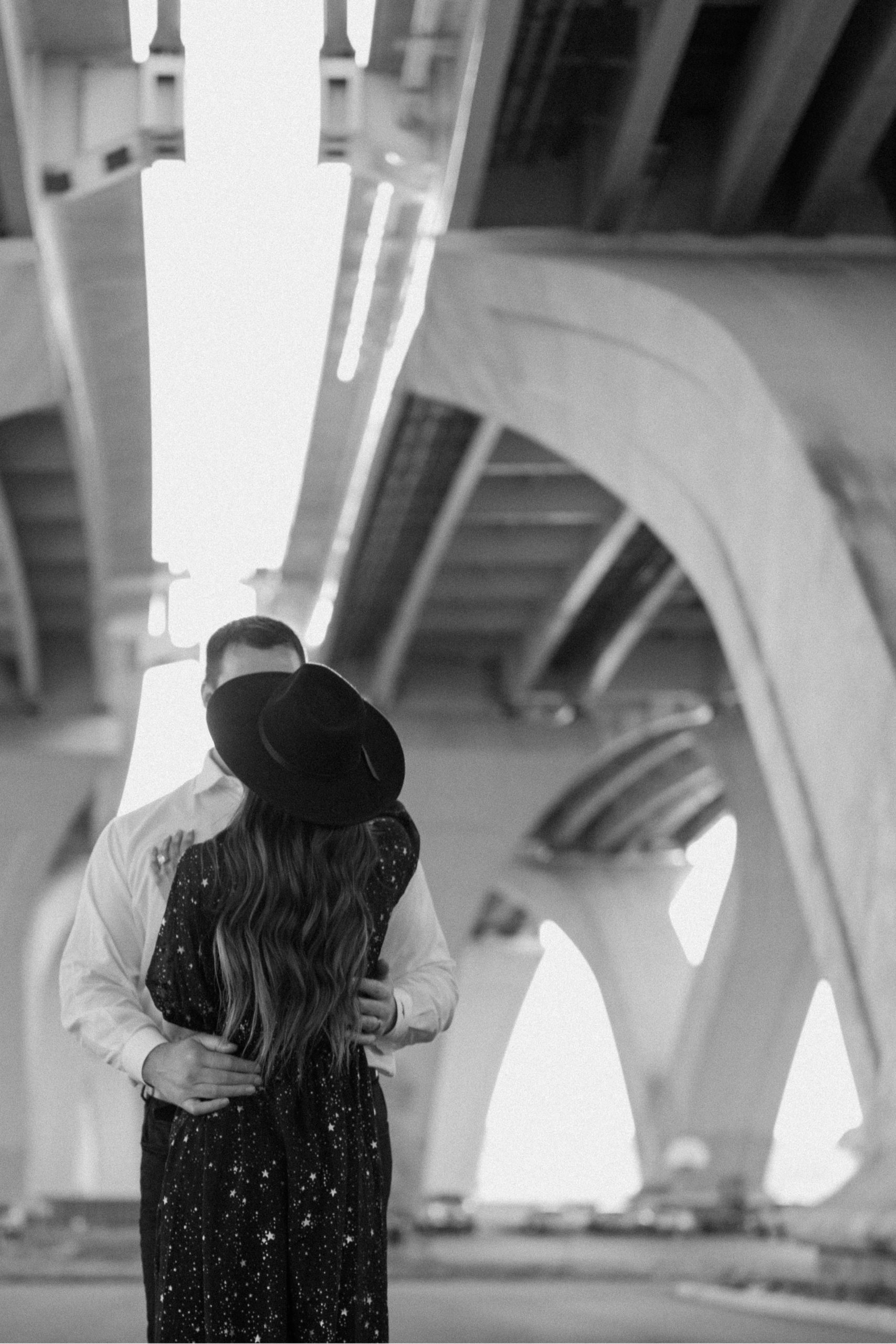 A married couple poses for their Alexandria, Virginia wedding anniversary photo session at Jones Point Park with Colorado photographer, Ashley Joyce Photography. Copyright Ashley Joyce Photography 2022.