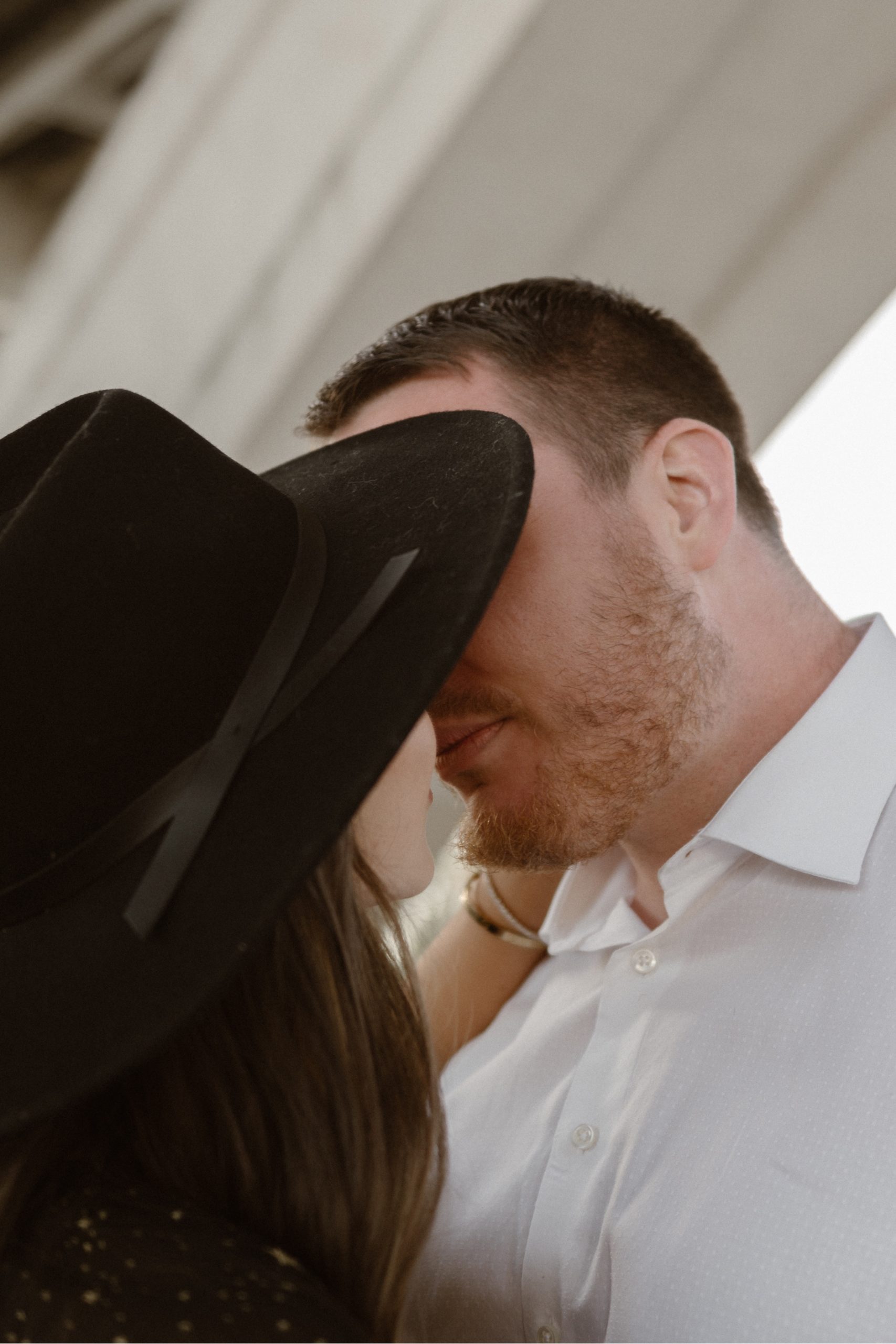 A married couple poses for their Alexandria, Virginia wedding anniversary photo session at Jones Point Park with Colorado photographer, Ashley Joyce Photography. Copyright Ashley Joyce Photography 2022.