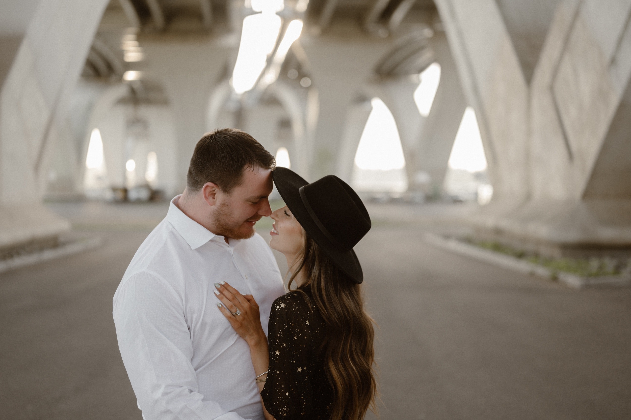 A married couple poses for their Alexandria, Virginia wedding anniversary photo session at Jones Point Park with Colorado photographer, Ashley Joyce Photography. Copyright Ashley Joyce Photography 2022.