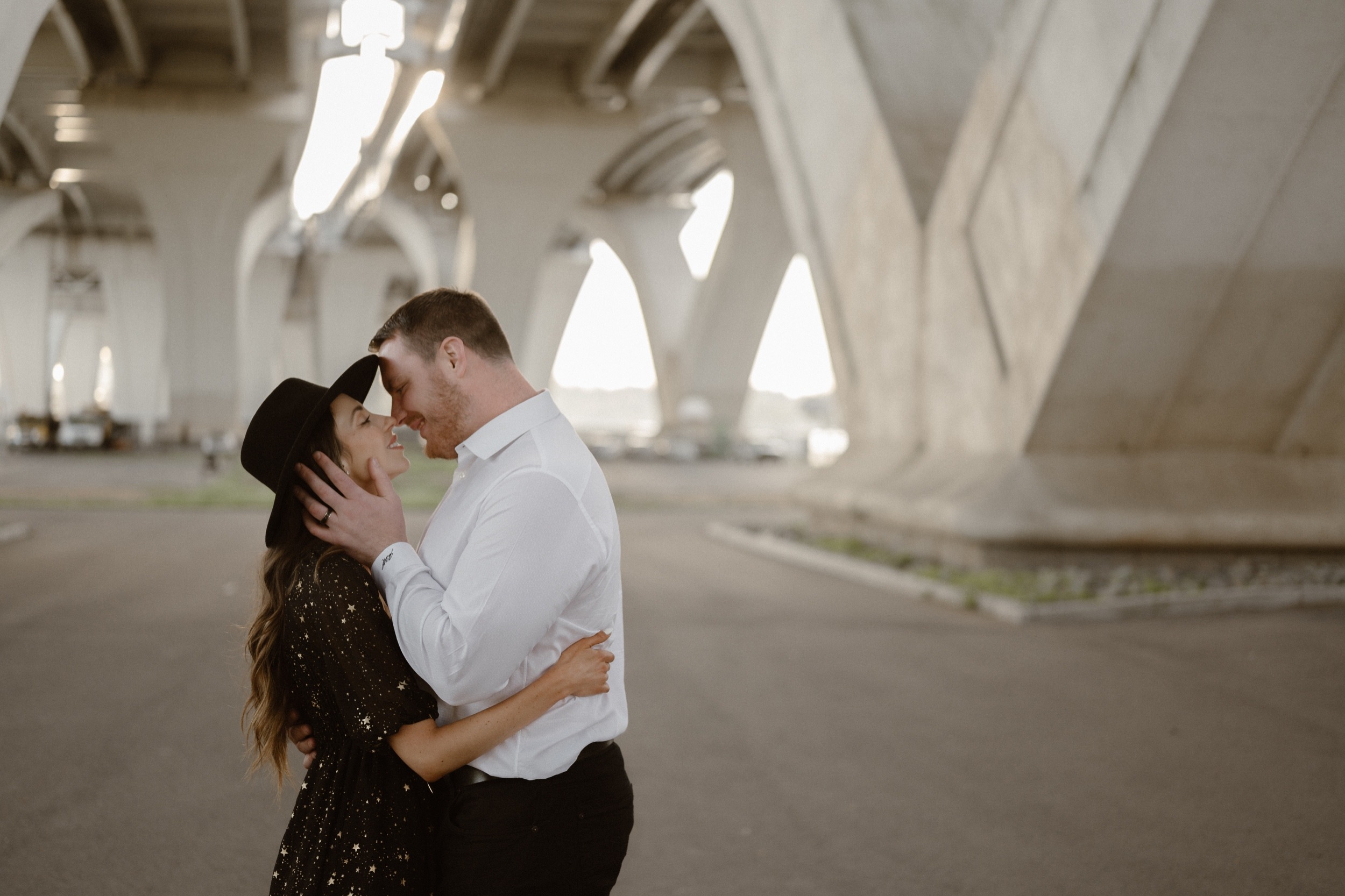 A married couple poses for their Alexandria, Virginia wedding anniversary photo session at Jones Point Park with Colorado photographer, Ashley Joyce Photography. Copyright Ashley Joyce Photography 2022.