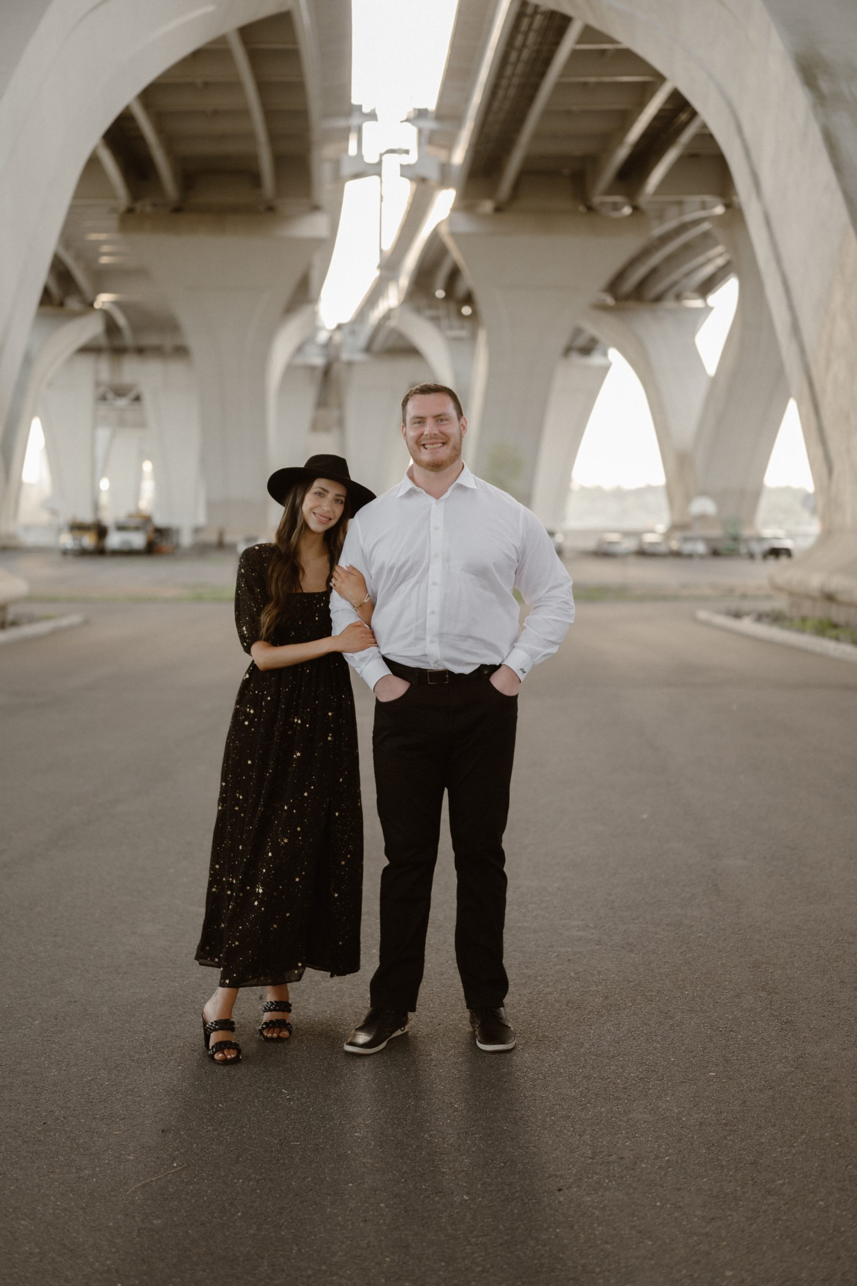 A married couple poses for their Alexandria, Virginia wedding anniversary photo session at Jones Point Park with Colorado photographer, Ashley Joyce Photography. Copyright Ashley Joyce Photography 2022.