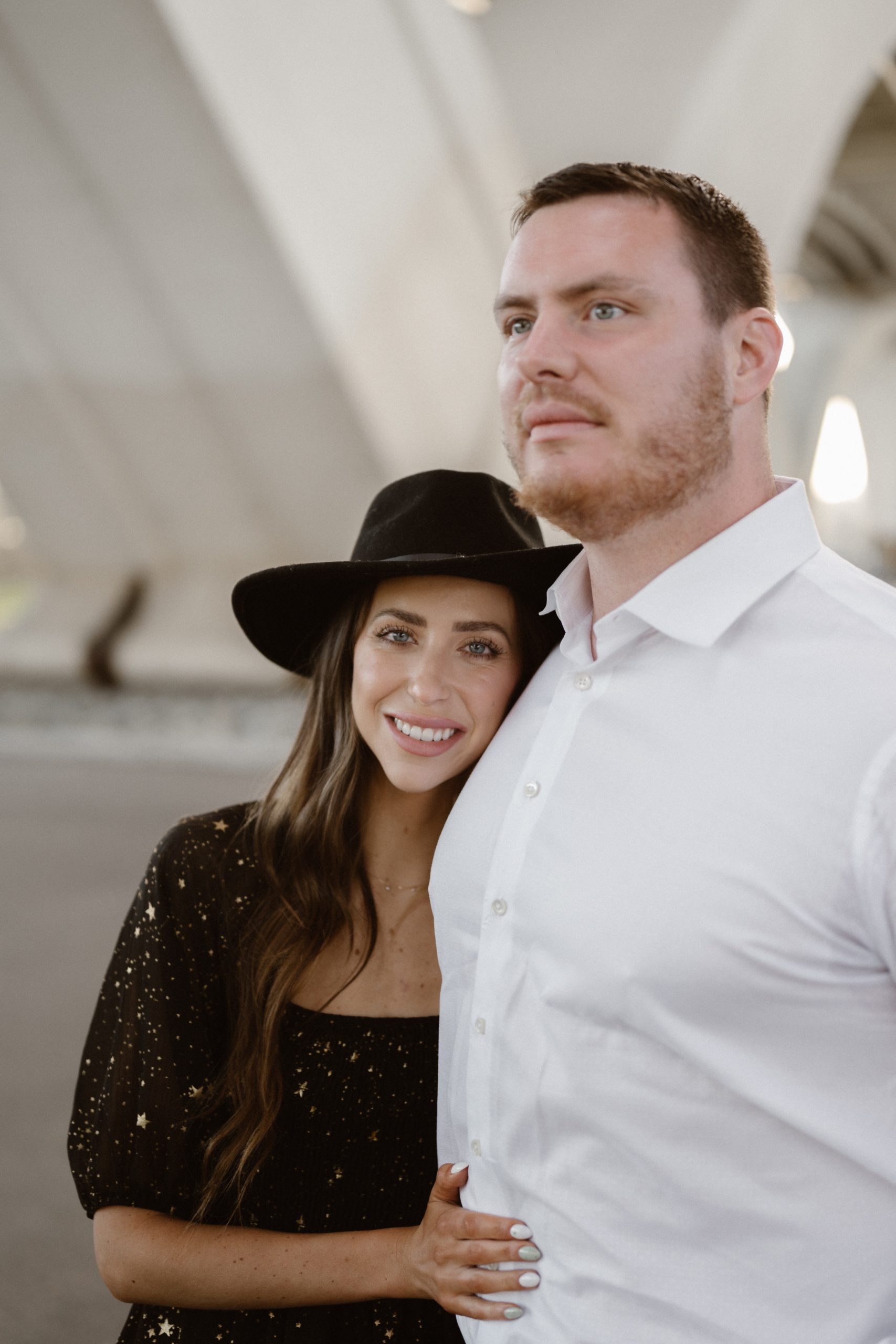 A married couple poses for their Alexandria, Virginia wedding anniversary photo session at Jones Point Park with Colorado photographer, Ashley Joyce Photography. Copyright Ashley Joyce Photography 2022.