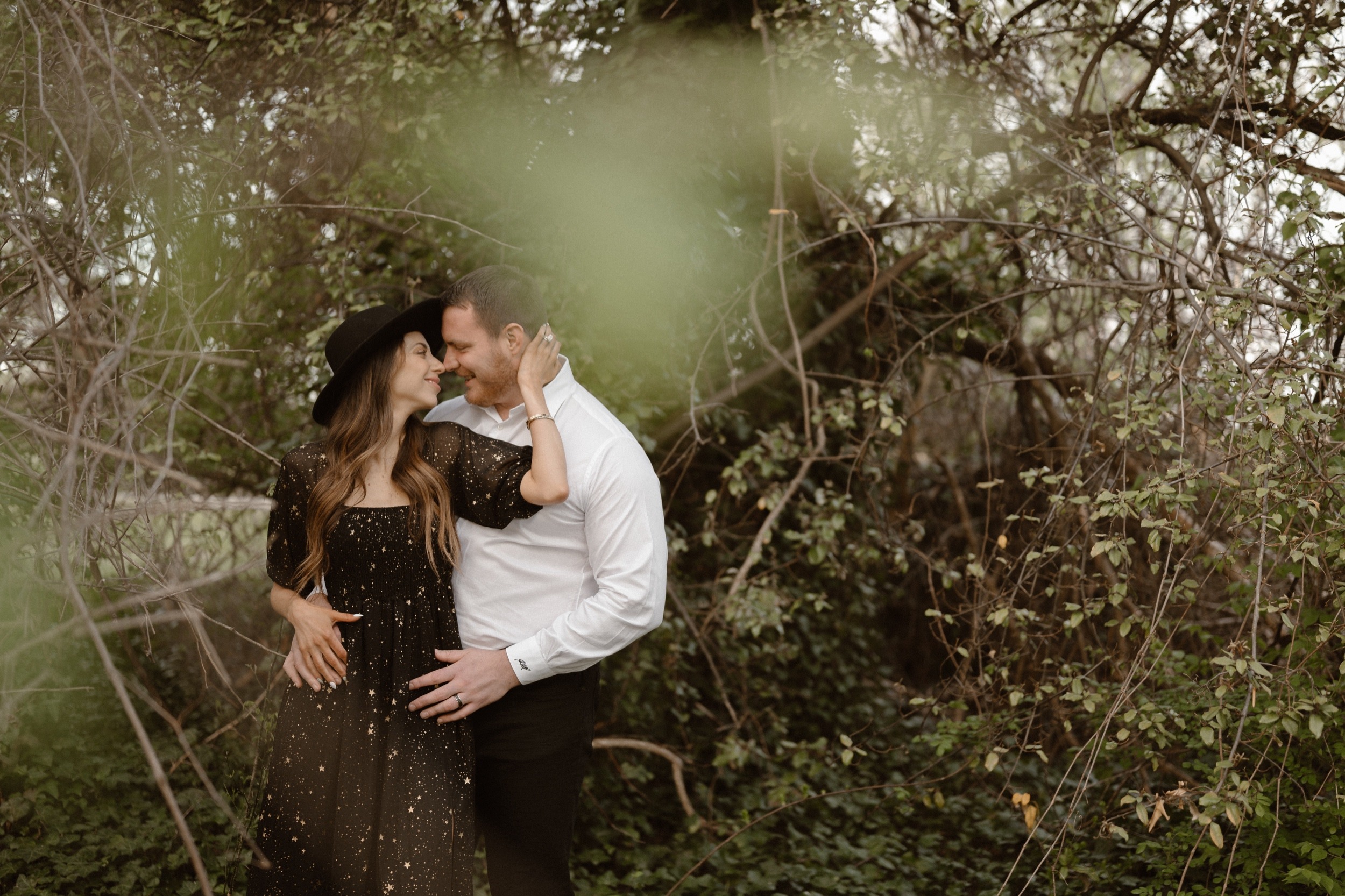 A married couple poses for their Alexandria, Virginia wedding anniversary photo session at Jones Point Park with Colorado photographer, Ashley Joyce Photography. Copyright Ashley Joyce Photography 2022.
