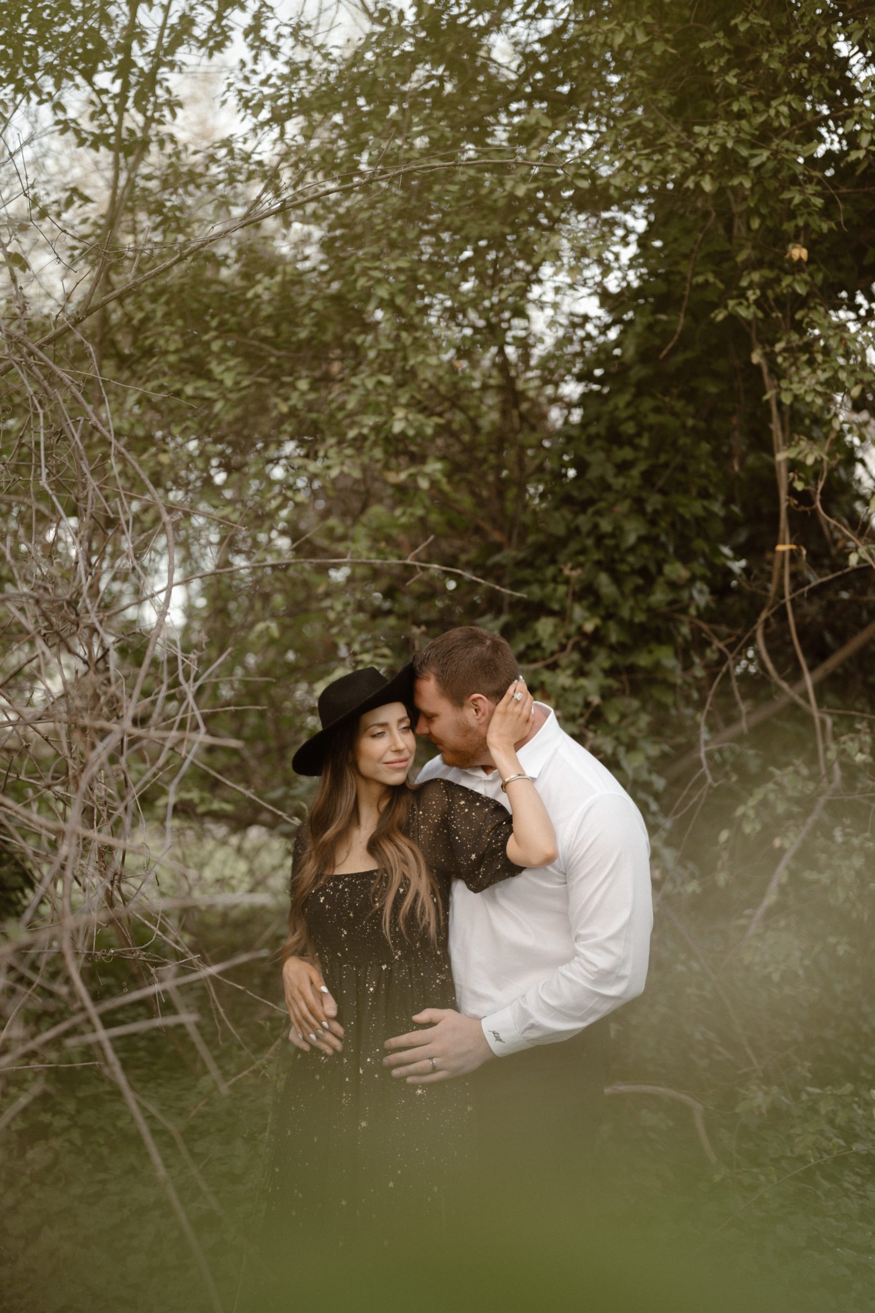 A married couple poses for their Alexandria, Virginia wedding anniversary photo session at Jones Point Park with Colorado photographer, Ashley Joyce Photography. Copyright Ashley Joyce Photography 2022.