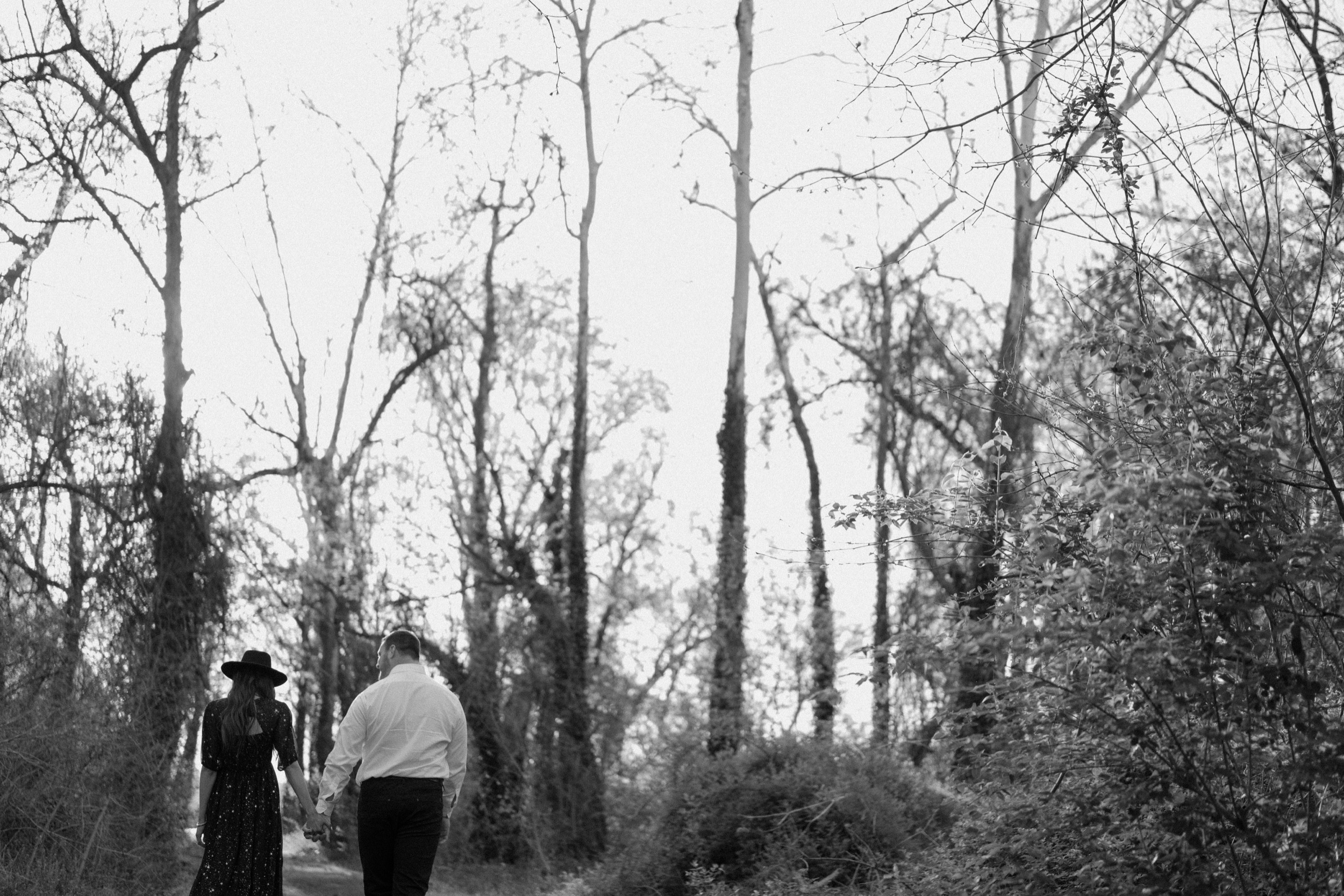 A married couple poses for their Alexandria, Virginia wedding anniversary photo session at Jones Point Park with Colorado photographer, Ashley Joyce Photography. Copyright Ashley Joyce Photography 2022.