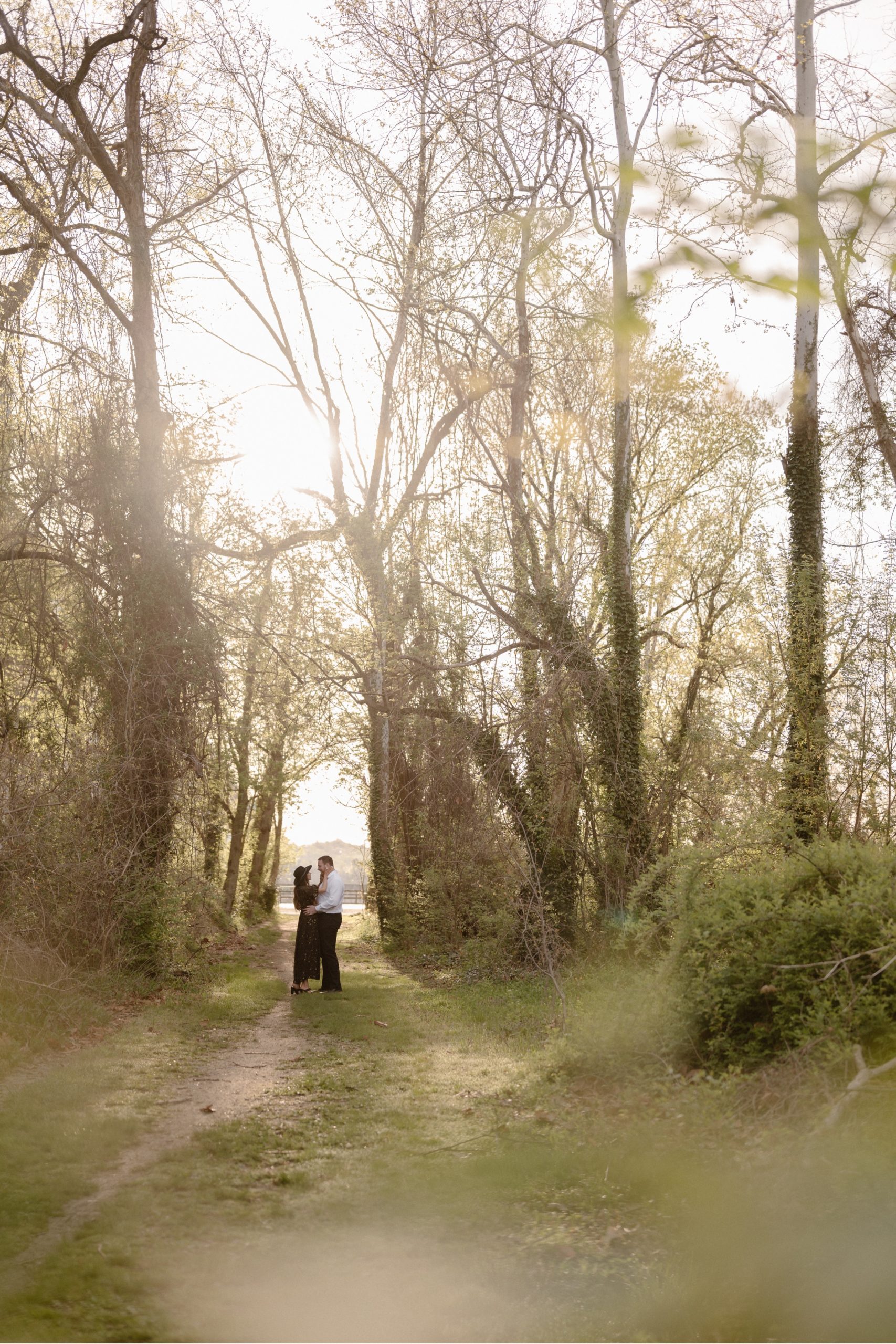 A married couple poses for their Alexandria, Virginia wedding anniversary photo session at Jones Point Park with Colorado photographer, Ashley Joyce Photography. Copyright Ashley Joyce Photography 2022.