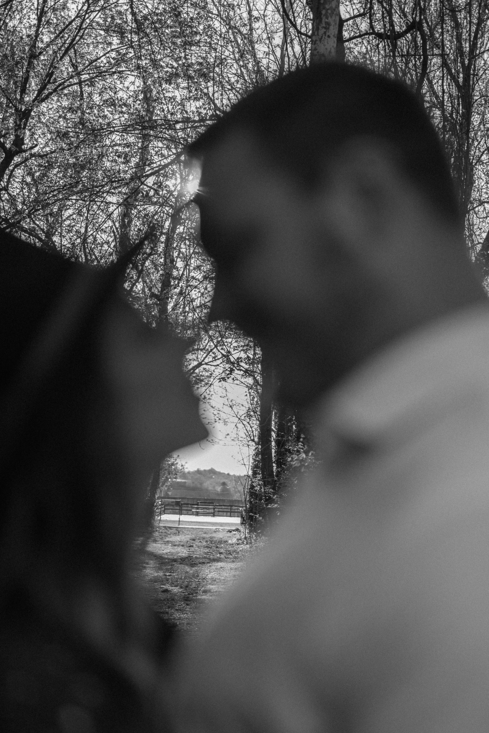 A married couple poses for their Alexandria, Virginia wedding anniversary photo session at Jones Point Park with Colorado photographer, Ashley Joyce Photography. Copyright Ashley Joyce Photography 2022.