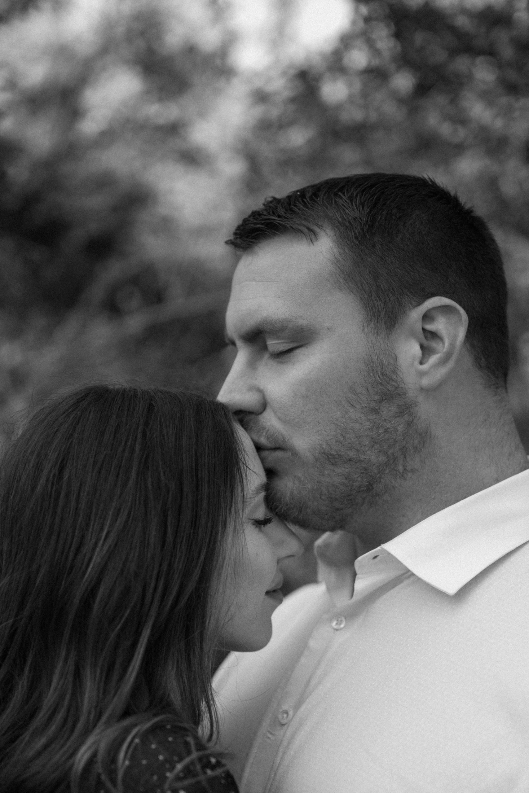 A married couple poses for their Alexandria, Virginia wedding anniversary photo session at Jones Point Park with Colorado photographer, Ashley Joyce Photography. Copyright Ashley Joyce Photography 2022.