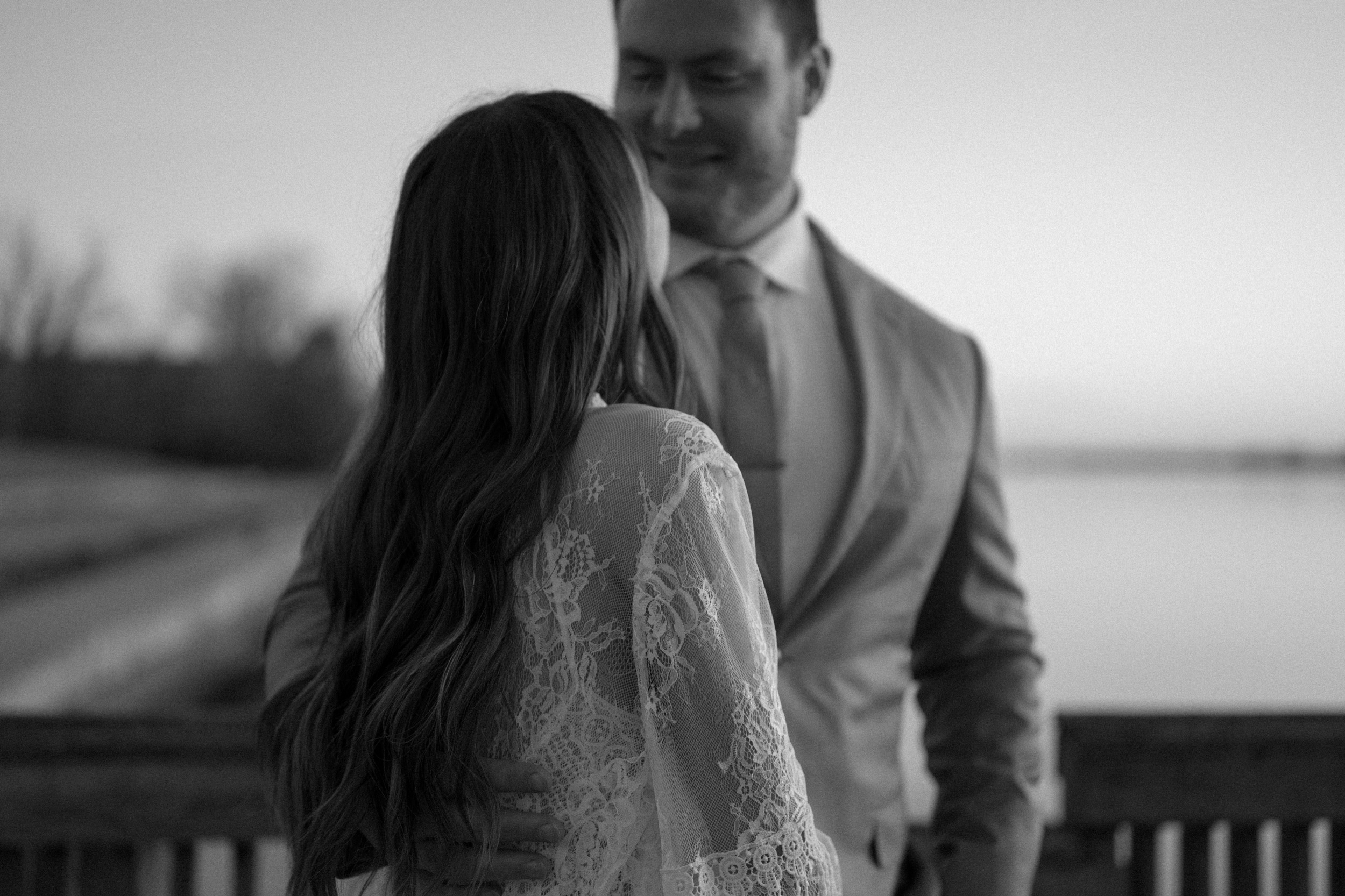 A married couple poses for their Alexandria, Virginia wedding anniversary photo session at Jones Point Park with Colorado photographer, Ashley Joyce Photography. Copyright Ashley Joyce Photography 2022.