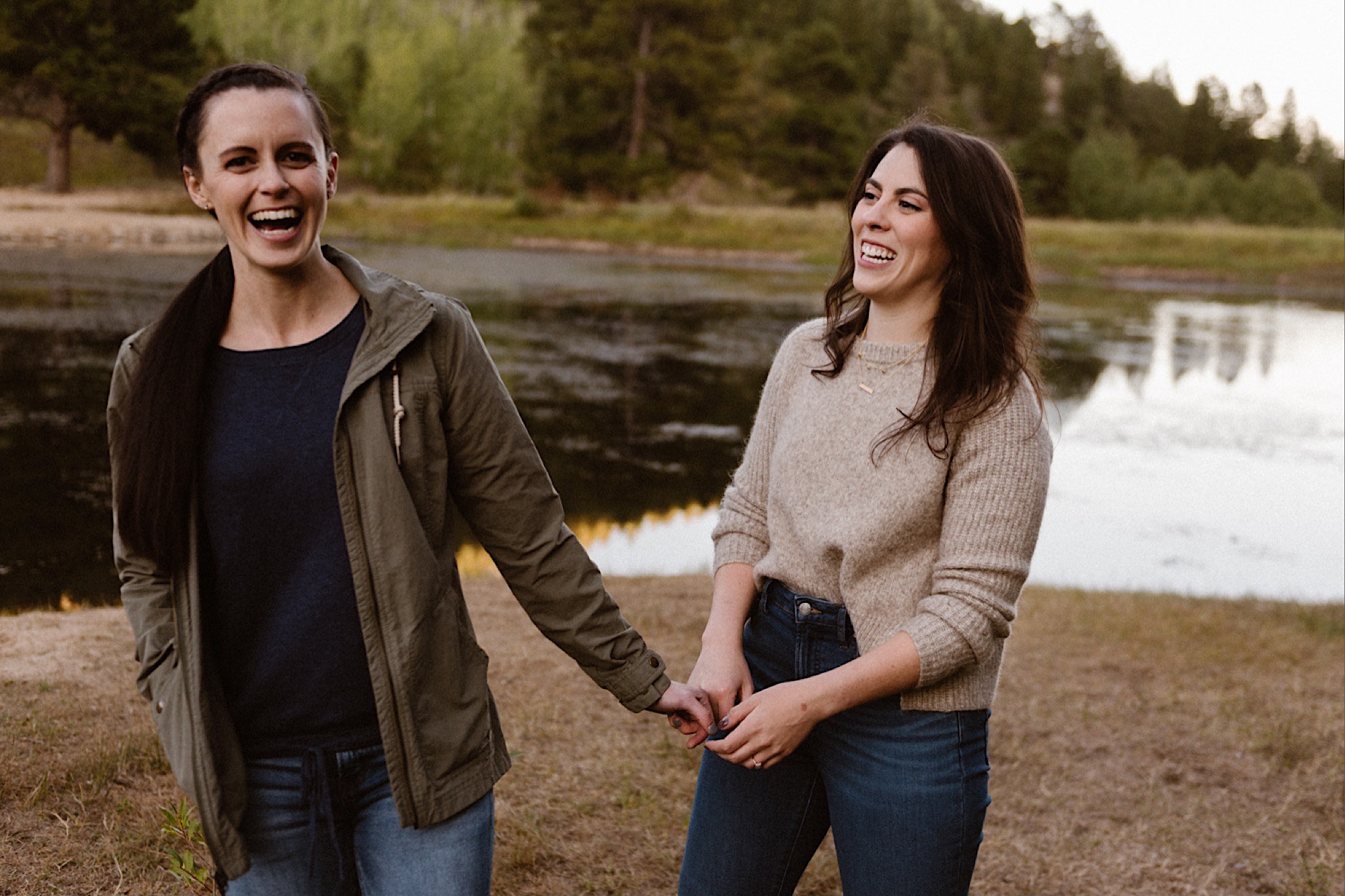 A lesbian engagement couple cuddles together at Golden Gate Canyon State Park for their Colorado engagement photos. Lesbian engagement photos | LGBTQ engagement photos in Denver | Denver engagement photos | Boulder engagement photos | Colorado engagement photos | LGBTQ Colorado engagement | Photo by Colorado elopement photographer, Denver elopement photographer, Ashley Joyce Photography.
