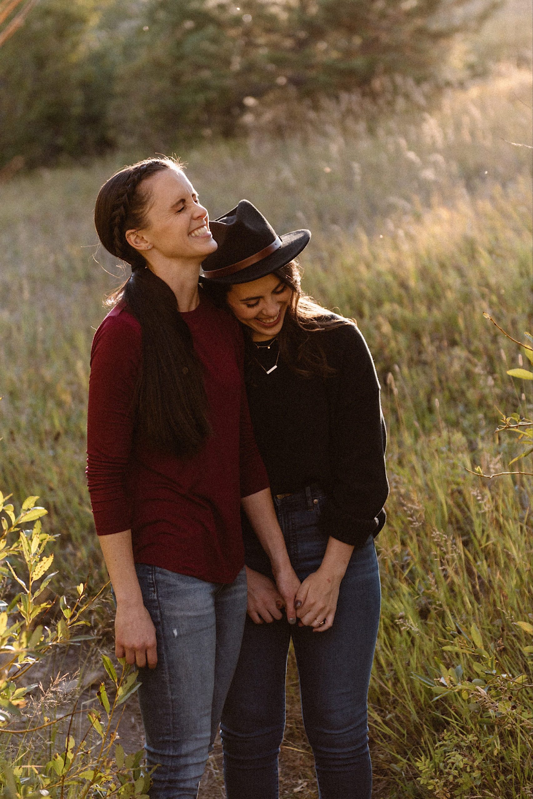 A lesbian engagement couple walks on the forest trail at Golden Gate Canyon State Park for their Colorado engagement photos. Lesbian engagement photos. LGBTQ engagement photos in Denver. Photo by Colorado elopement photographer, Denver elopement photographer, Ashley Joyce Photography.