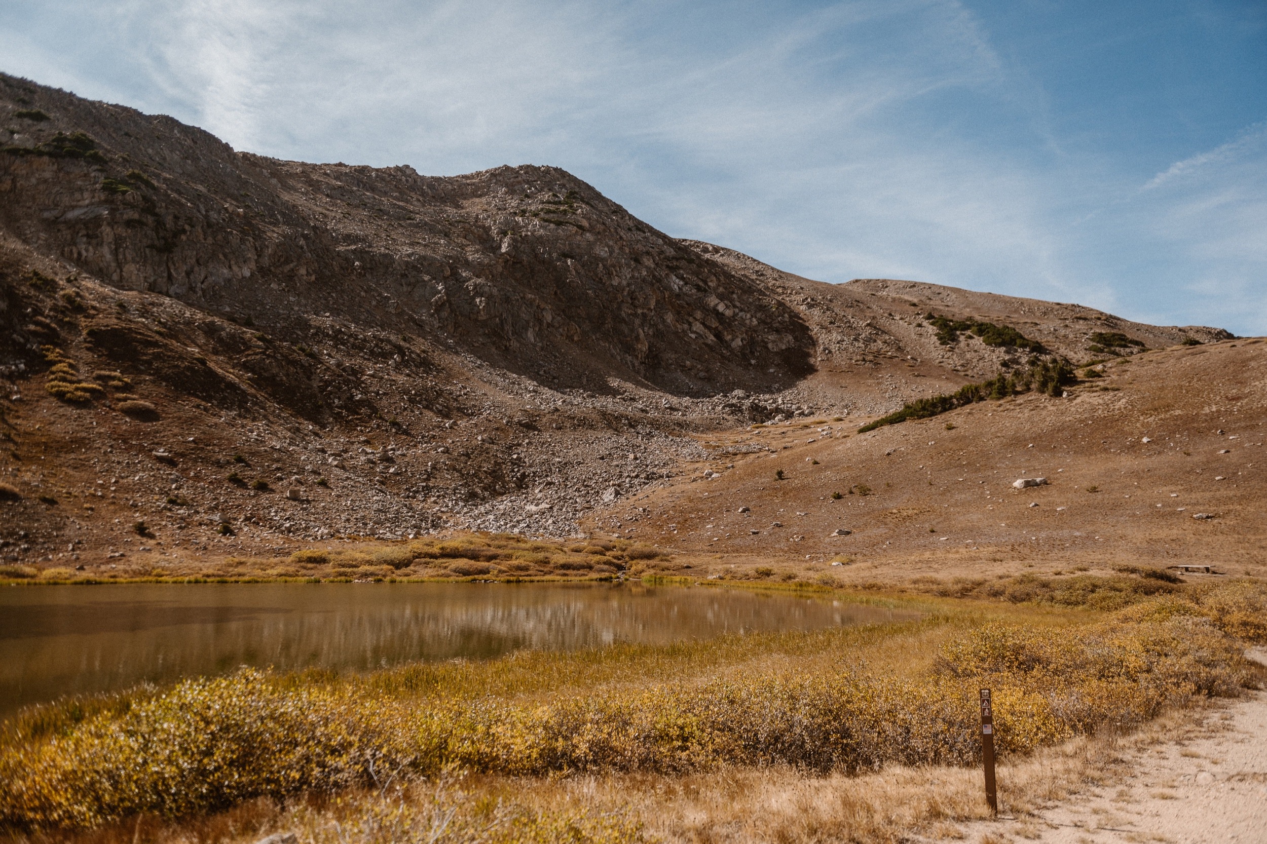 A Colorado engaged couple poses for their engagement photos at Loveland Pass, Colorado. Photos by Denver Elopement Photographer, Ashley Joyce Photography, 2022.