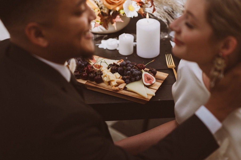 Charcuterie board detail with bride and groom | Wedding portraits | Elopement portraits | Bride and groom elopement photos | Elopement wedding photos in Colorado | Colorado wedding photos | Colorado elopement photos | Elopement at Treehaus, Colorado | Treehaus Colorado | Colorado elopement | Treehaus elopement | Colorado elopement venue | Colorado mountain elopement venue | Unique elopement venue | Elopement venue in Colorado | Ashley Joyce Photography 2020