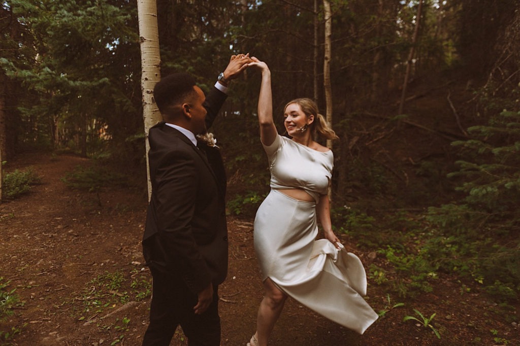 Bride and groom dancing in the woods in Colorado | Wedding portraits | Elopement portraits | Bride and groom elopement photos | Elopement wedding photos in Colorado | Colorado wedding photos | Colorado elopement photos | Elopement at Treehaus, Colorado | Treehaus Colorado | Colorado elopement | Treehaus elopement | Colorado elopement venue | Colorado mountain elopement venue | Unique elopement venue | Elopement venue in Colorado | Ashley Joyce Photography 2020