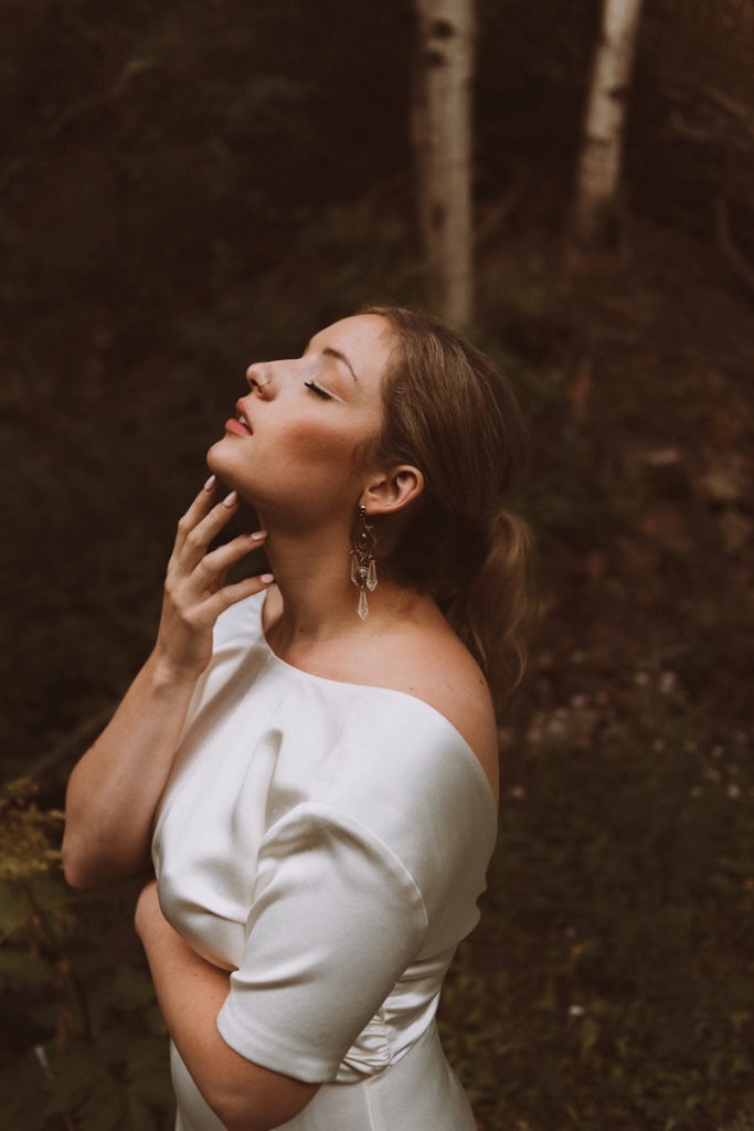 Bridal details | Bride standing in the woods in Colorado at Treehaus, Colorado | Wedding portraits | Elopement portraits | Bride and groom elopement photos | Elopement wedding photos in Colorado | Colorado wedding photos | Colorado elopement photos | Elopement at Treehaus, Colorado | Treehaus Colorado | Colorado elopement | Treehaus elopement | Colorado elopement venue | Colorado mountain elopement venue | Unique elopement venue | Elopement venue in Colorado | Ashley Joyce Photography 2020