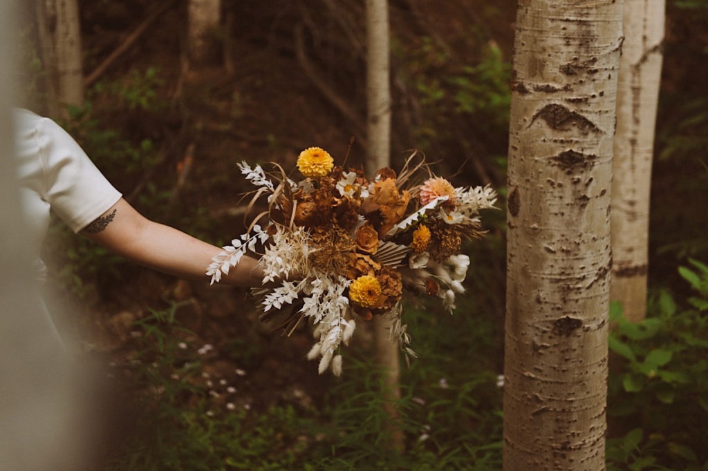 Bride holding bouquet | Bridal bouquet | Bridal bouquet detail | Wedding portraits | Elopement portraits | Bride and groom elopement photos | Elopement wedding photos in Colorado | Colorado wedding photos | Colorado elopement photos | Elopement at Treehaus, Colorado | Treehaus Colorado | Colorado elopement | Treehaus elopement | Colorado elopement venue | Colorado mountain elopement venue | Unique elopement venue | Elopement venue in Colorado | Ashley Joyce Photography 2020