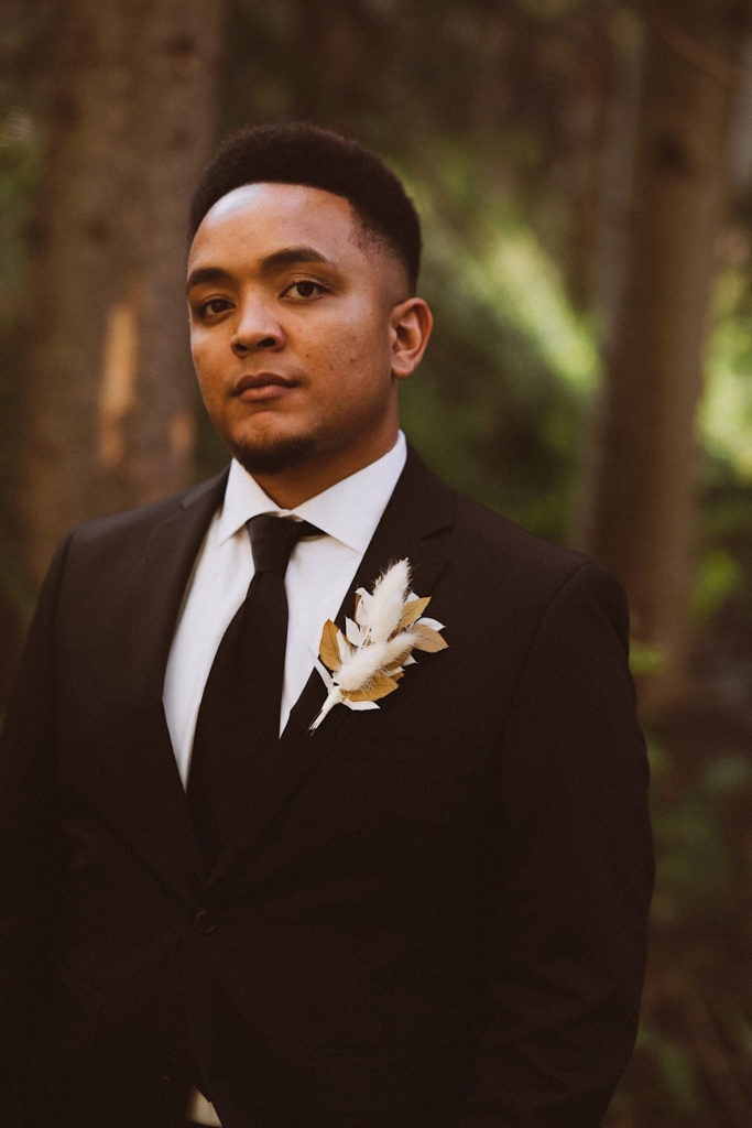 Groom standing in the forest in Colorado | Groom attire | Wedding portraits | Elopement portraits | Bride and groom elopement photos | Elopement wedding photos in Colorado | Colorado wedding photos | Colorado elopement photos | Elopement at Treehaus, Colorado | Treehaus Colorado | Colorado elopement | Treehaus elopement | Colorado elopement venue | Colorado mountain elopement venue | Unique elopement venue | Elopement venue in Colorado | Ashley Joyce Photography 2020