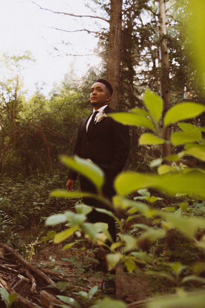 Groom standing in the forest in Colorado | Groom attire | Wedding portraits | Elopement portraits | Bride and groom elopement photos | Elopement wedding photos in Colorado | Colorado wedding photos | Colorado elopement photos | Elopement at Treehaus, Colorado | Treehaus Colorado | Colorado elopement | Treehaus elopement | Colorado elopement venue | Colorado mountain elopement venue | Unique elopement venue | Elopement venue in Colorado | Ashley Joyce Photography 2020