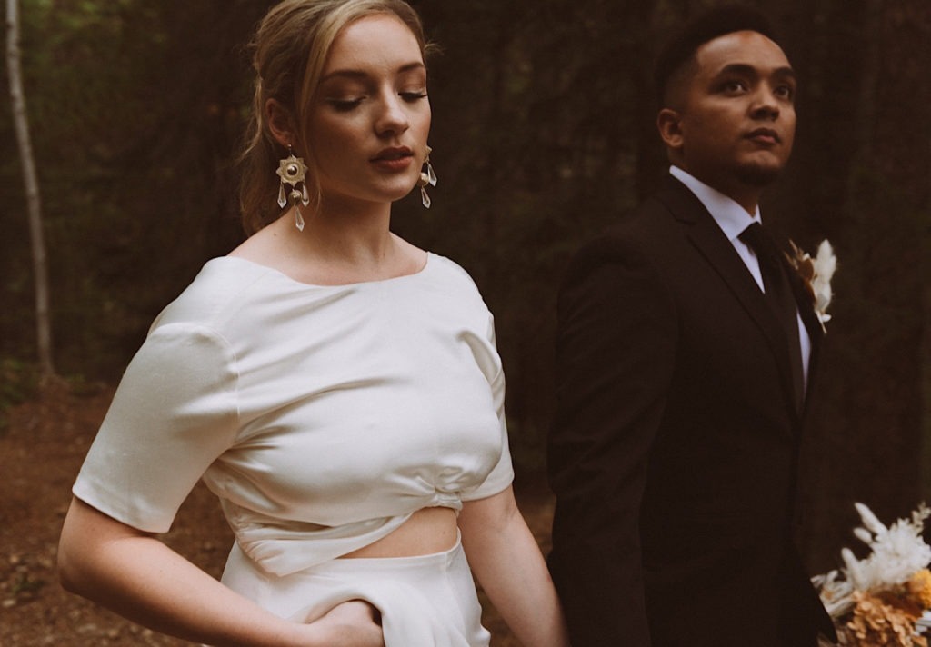 Bride and groom walking away in the forest of Colorado | Wedding portraits | Elopement portraits | Bride and groom elopement photos | Elopement wedding photos in Colorado | Colorado wedding photos | Colorado elopement photos | Elopement at Treehaus, Colorado | Treehaus Colorado | Colorado elopement | Treehaus elopement | Colorado elopement venue | Colorado mountain elopement venue | Unique elopement venue | Elopement venue in Colorado | Prea James Bridal | Prea James wedding dress | Lovely Bride Denver | Ashley Joyce Photography 2020