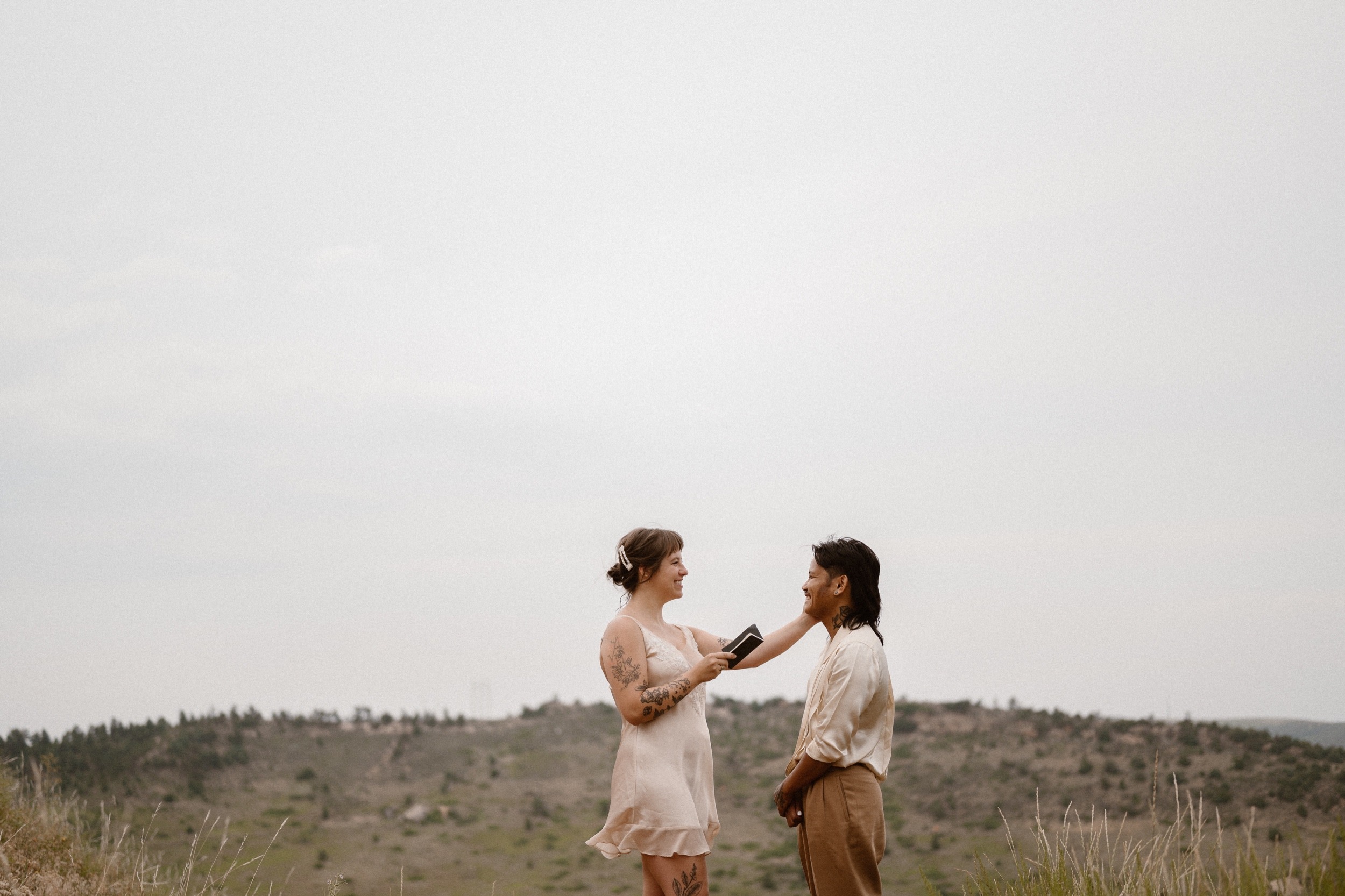 Colorado vow renewal in Morrison, Colorado. A Colorado married couple performs their vow renewal on a sunny summer day near Denver, Colorado. Photos by Denver elopement photographer, Ashley Joyce Photography, copyright 2022.