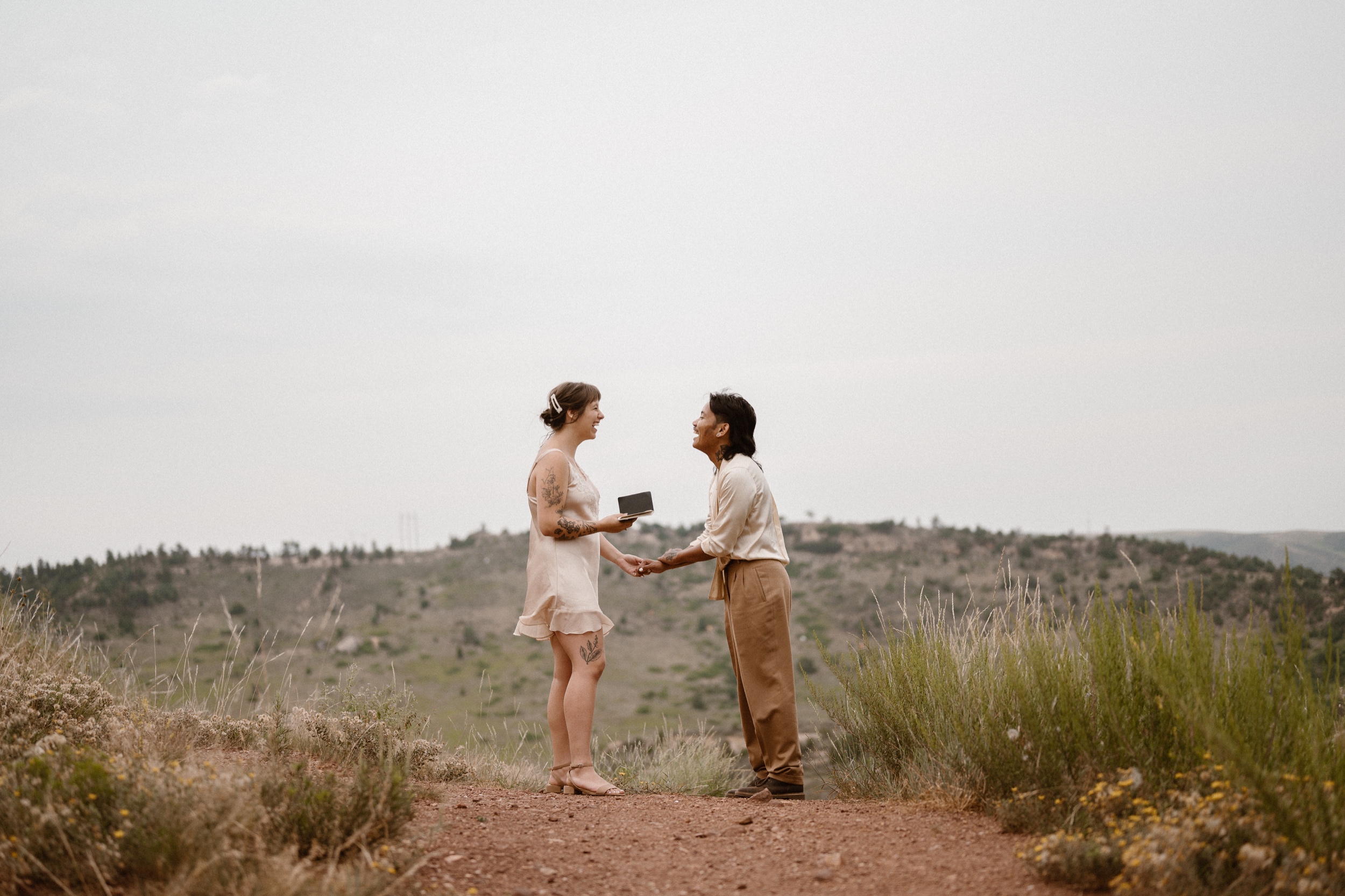 Colorado vow renewal in Morrison, Colorado. A Colorado married couple performs their vow renewal on a sunny summer day near Denver, Colorado. Photos by Denver elopement photographer, Ashley Joyce Photography, copyright 2022.