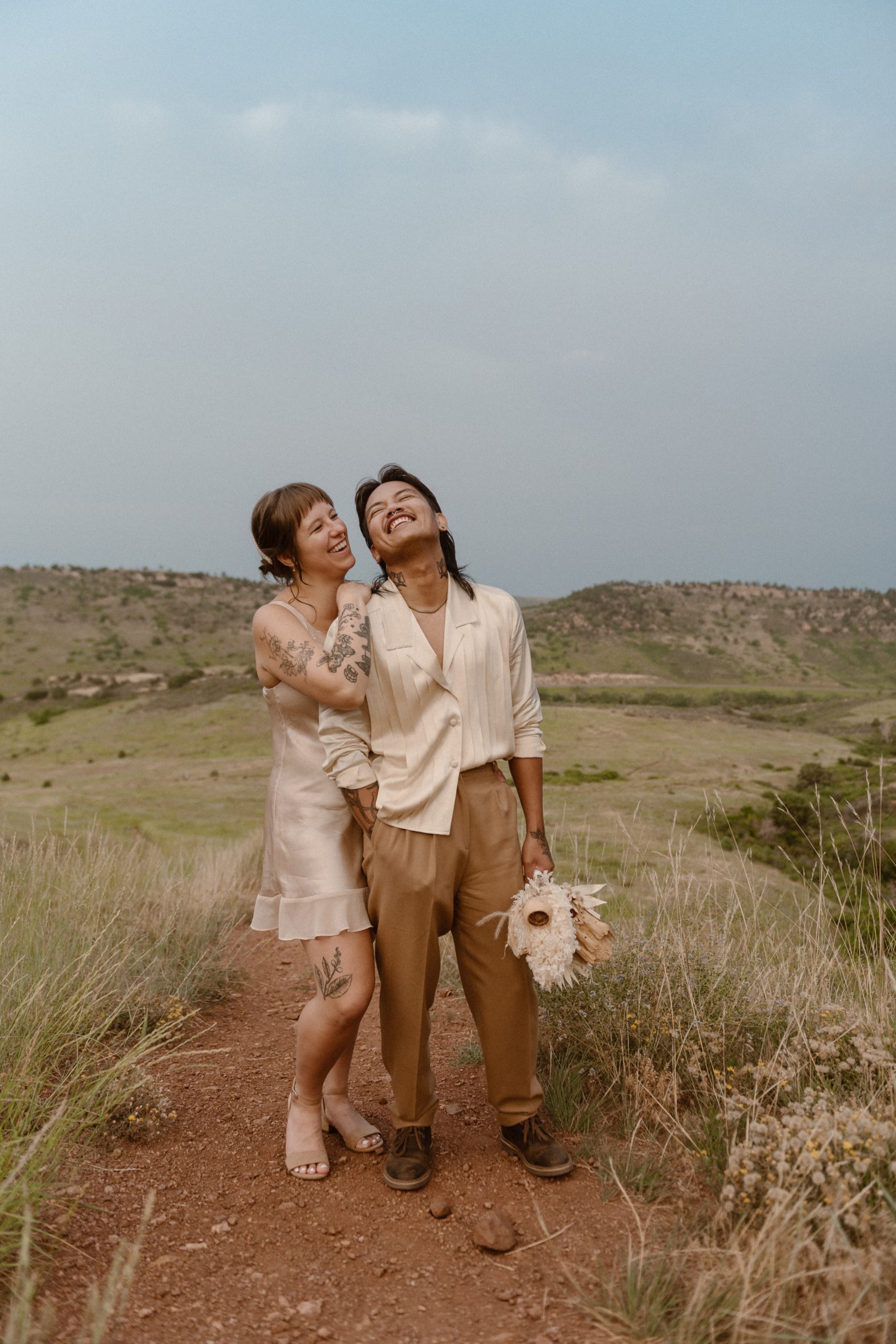 Colorado vow renewal in Morrison, Colorado. A Colorado married couple performs their vow renewal on a sunny summer day near Denver, Colorado. Photos by Denver elopement photographer, Ashley Joyce Photography, copyright 2022.
