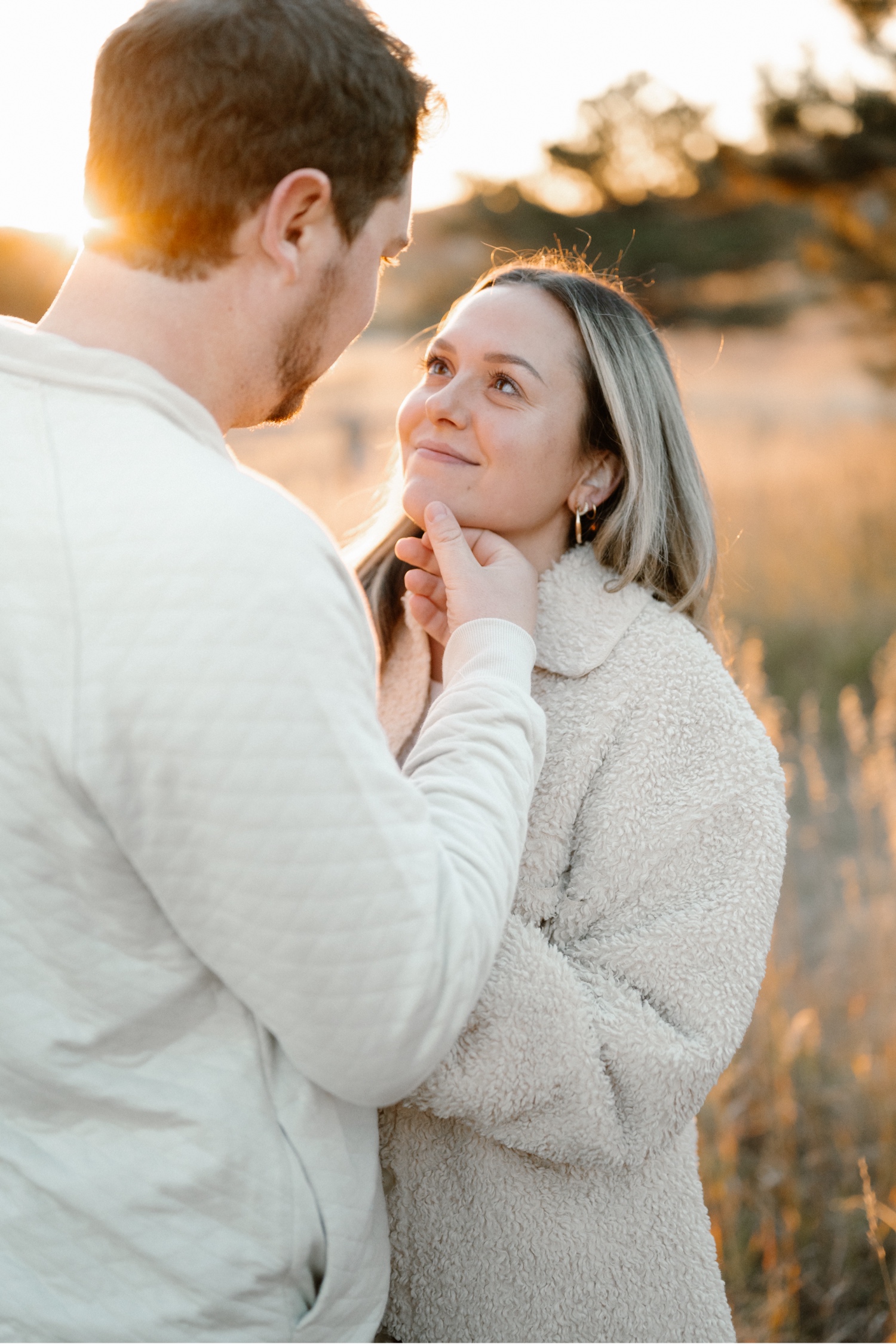 A photo of an engaged couple embracing each other in Elk Meadow Park in Evergreen, Colorado for their Colorado engagement photos, taken by Colorado wedding photographer Ashley Joyce Photography.