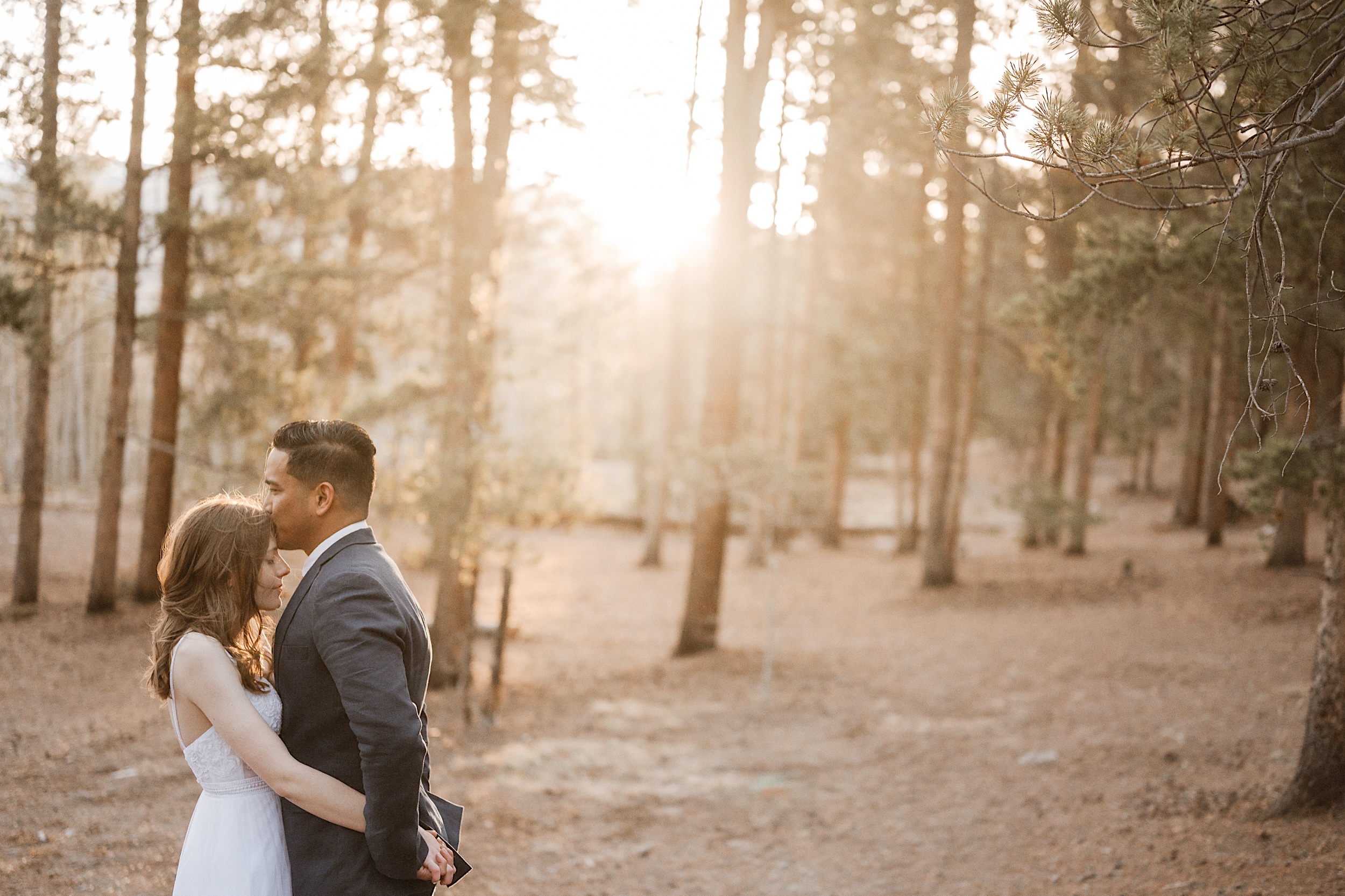 A bride and a groom pose for their Twin Lakes wedding session on a sunny autumn day. Photos by Ashley Joyce Photography.