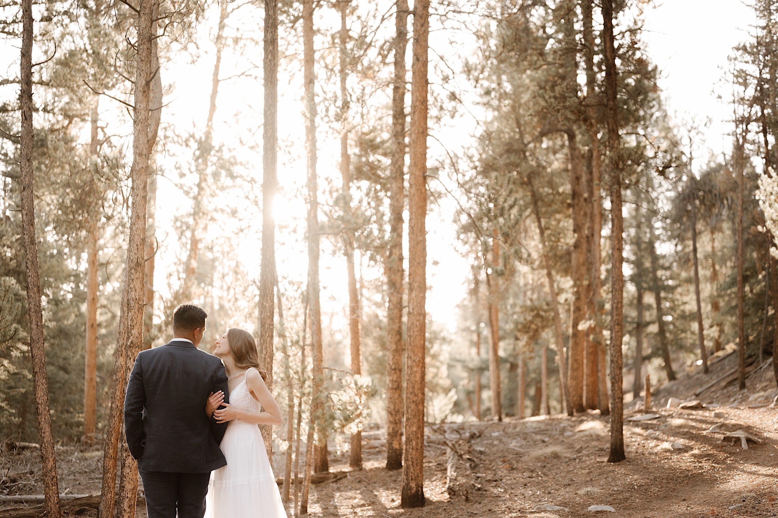 A bride and a groom pose for their Twin Lakes wedding session on a sunny autumn day. Photos by Ashley Joyce Photography.