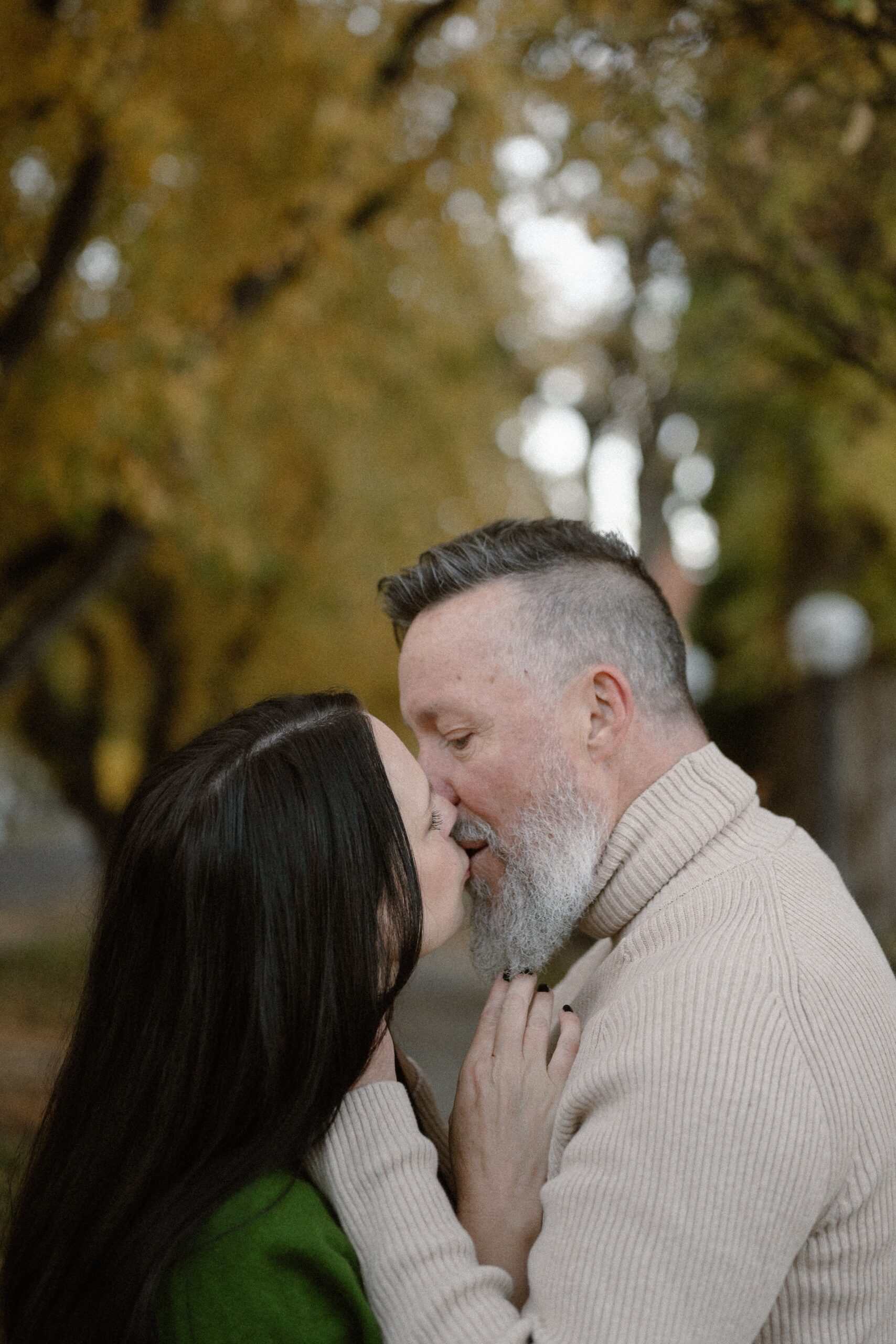 A color photo of an engaged couple kissing one another in Durango, Colorado for their engagement session, taken by Colorado wedding photographer, Ashley Joyce.