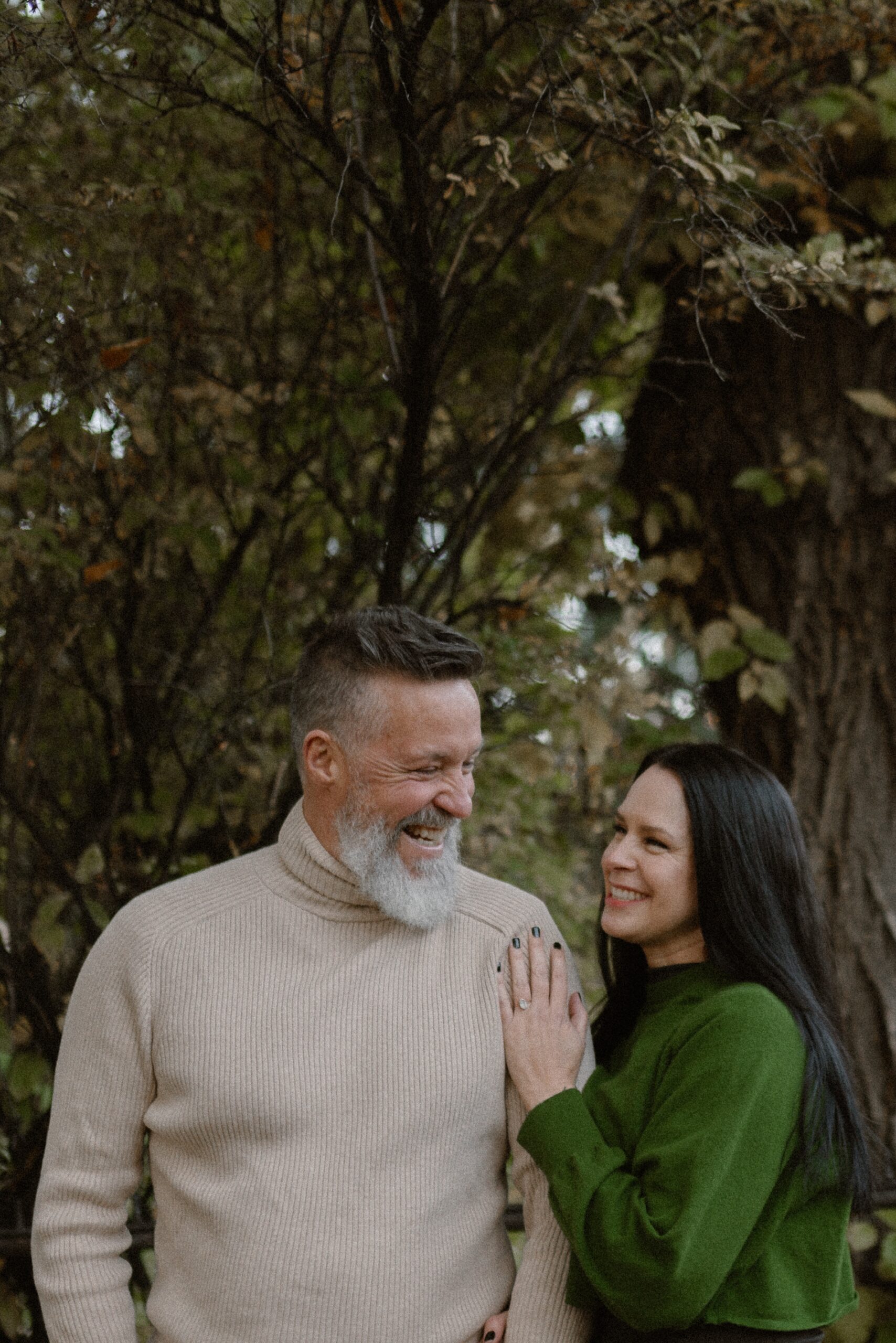 A color photo of an engaged couple laughing together for their Durango Colorado engagement session, taken by Colorado wedding photographer, Ashley Joyce.