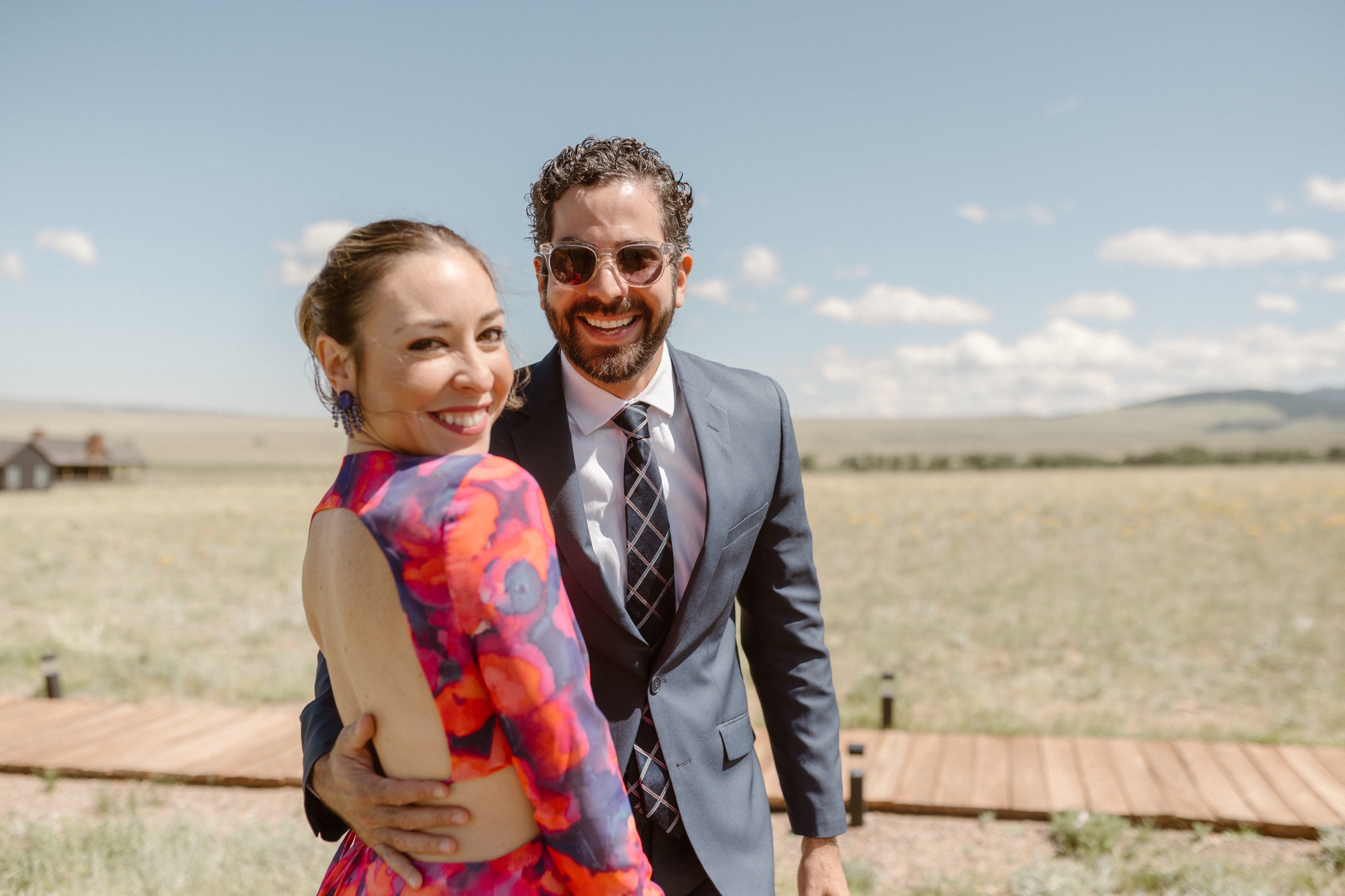 Two wedding guests smiling for the camera. Photo by Colorado wedding photographer, Ashley Joyce