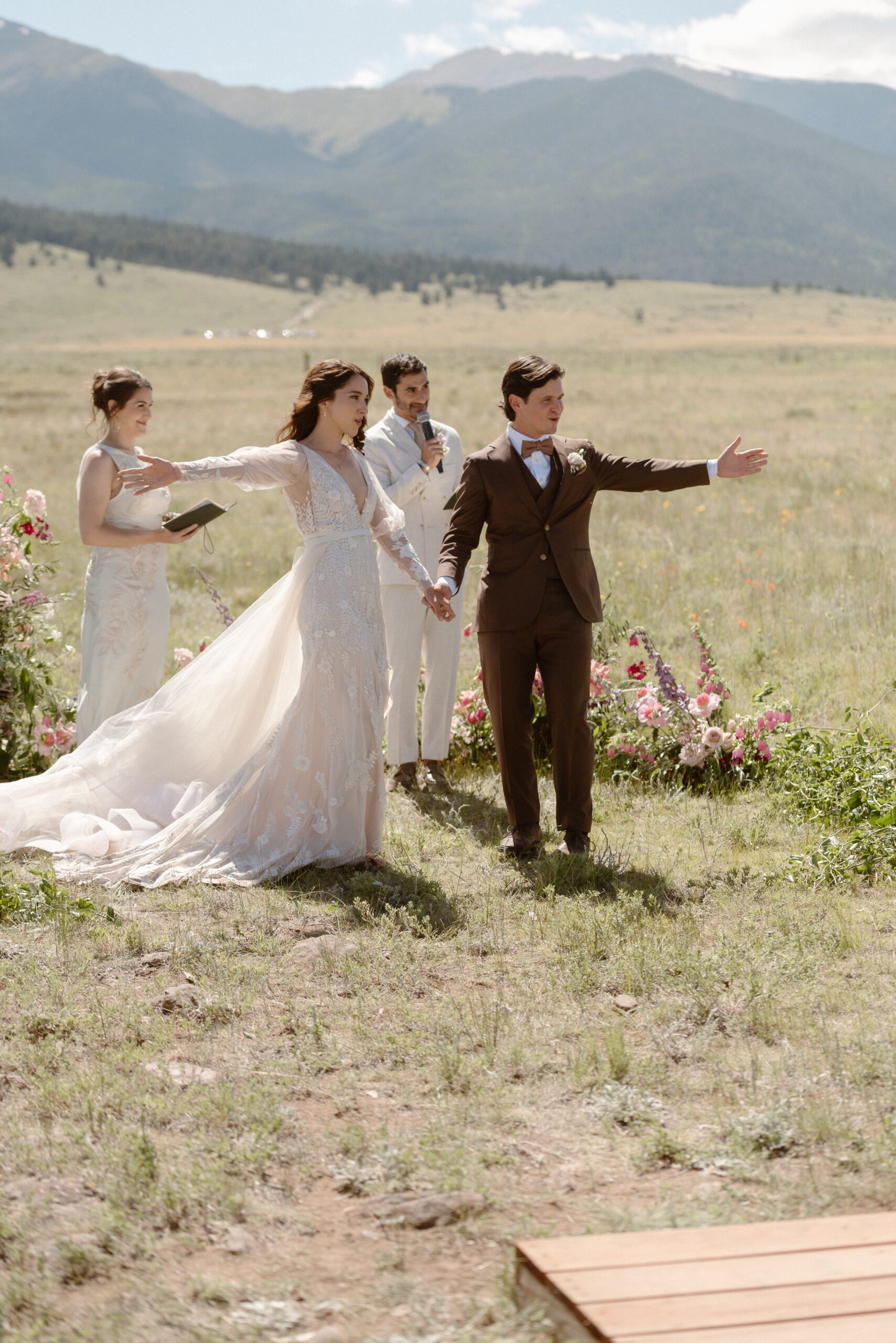 A bride and groom celebrate their wedding ceremony at Three Peaks Ranch. Photo by Colorado wedding photographer Ashley Joyce.
