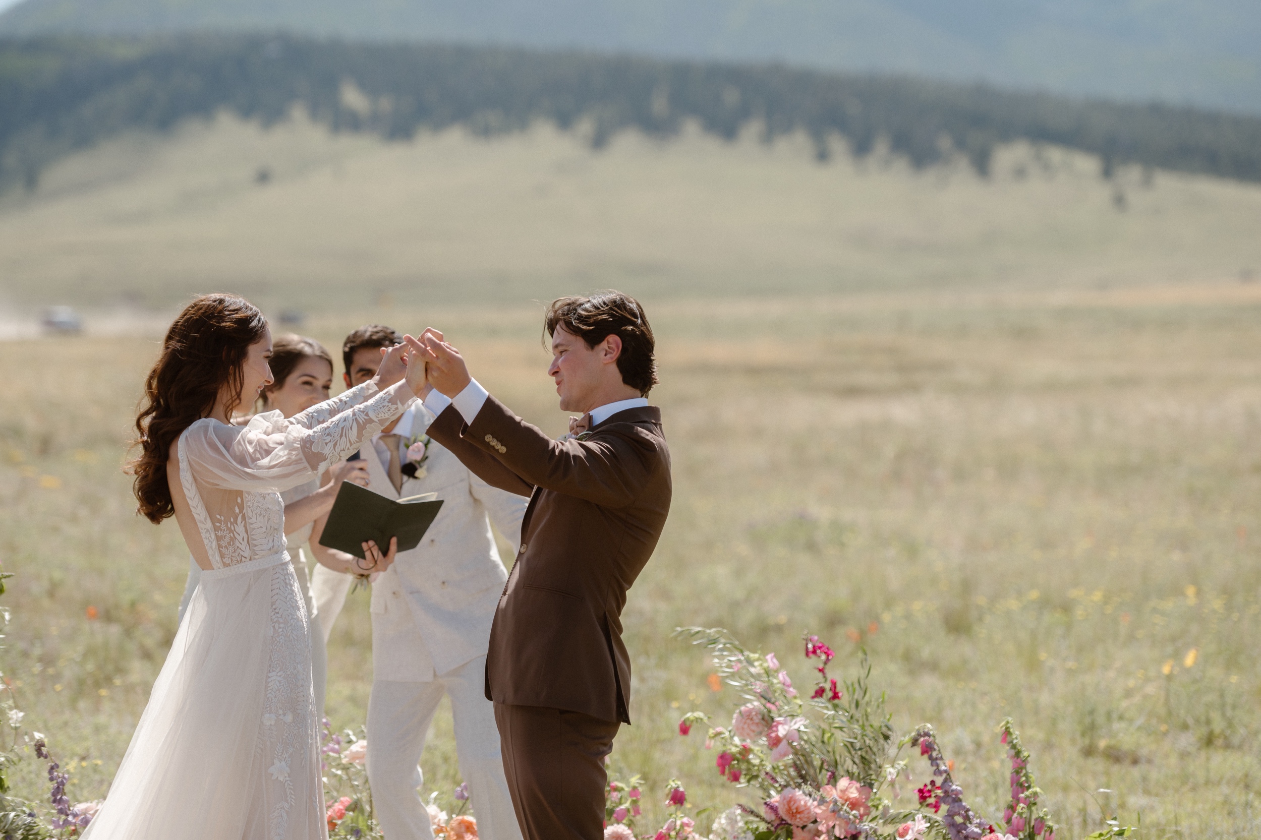 A bride and groom celebrate their wedding ceremony at Three Peaks Ranch. Photo by Colorado wedding photographer Ashley Joyce.