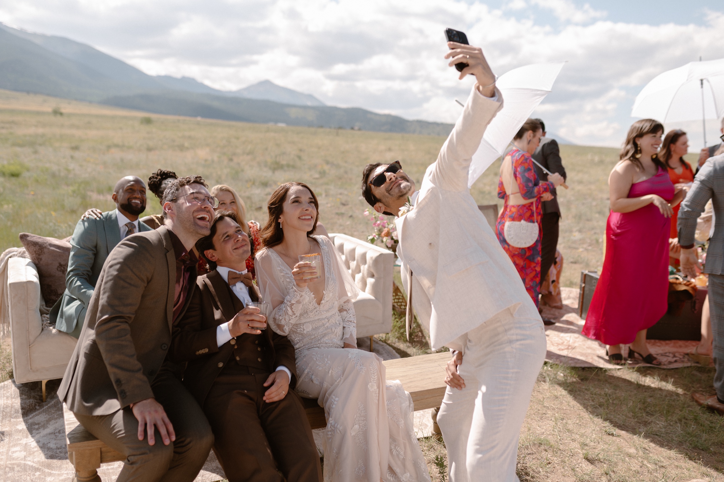Wedding guests pose for photos at a Three Peaks Ranch wedding. Photo by Colorado wedding photographer Ashley Joyce.