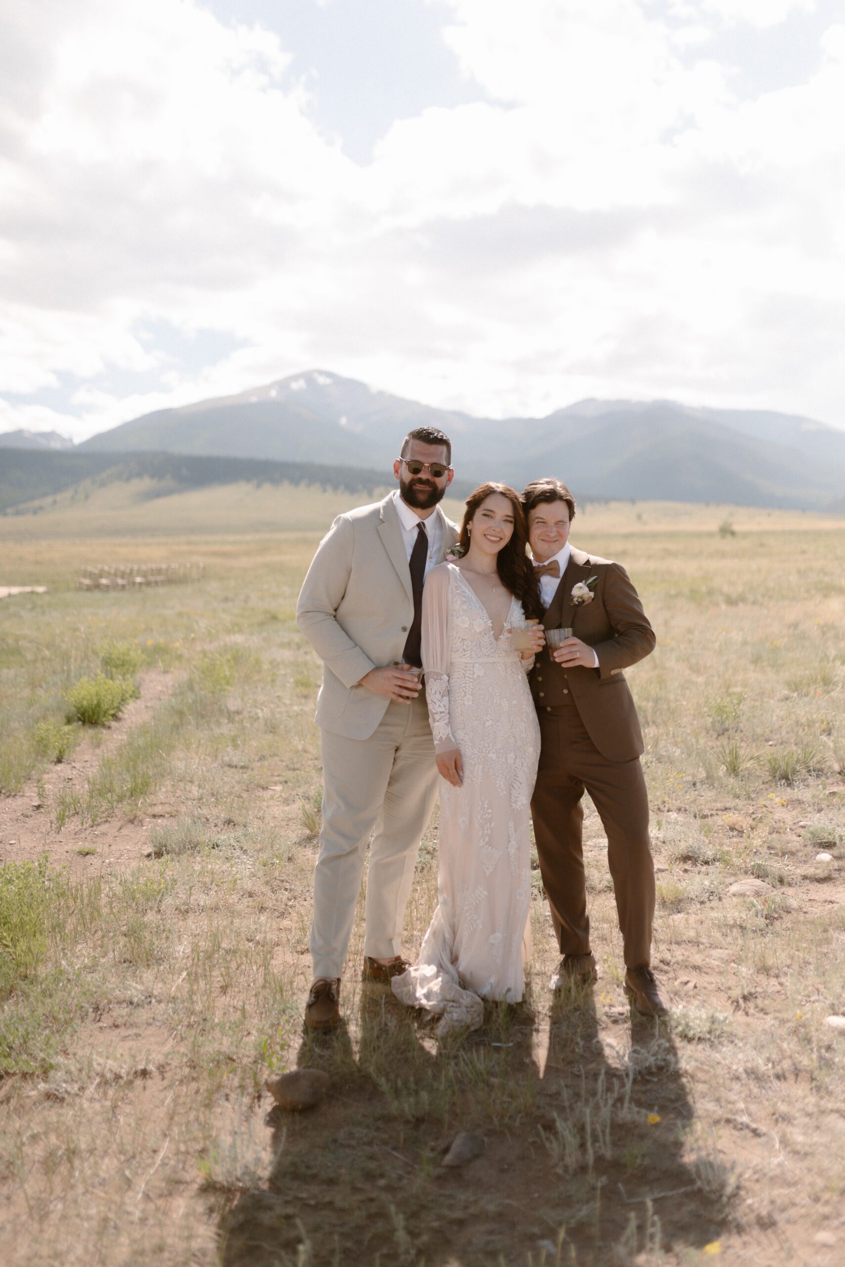 Wedding guests pose for photos at a Three Peaks Ranch wedding. Photo by Colorado wedding photographer Ashley Joyce.
