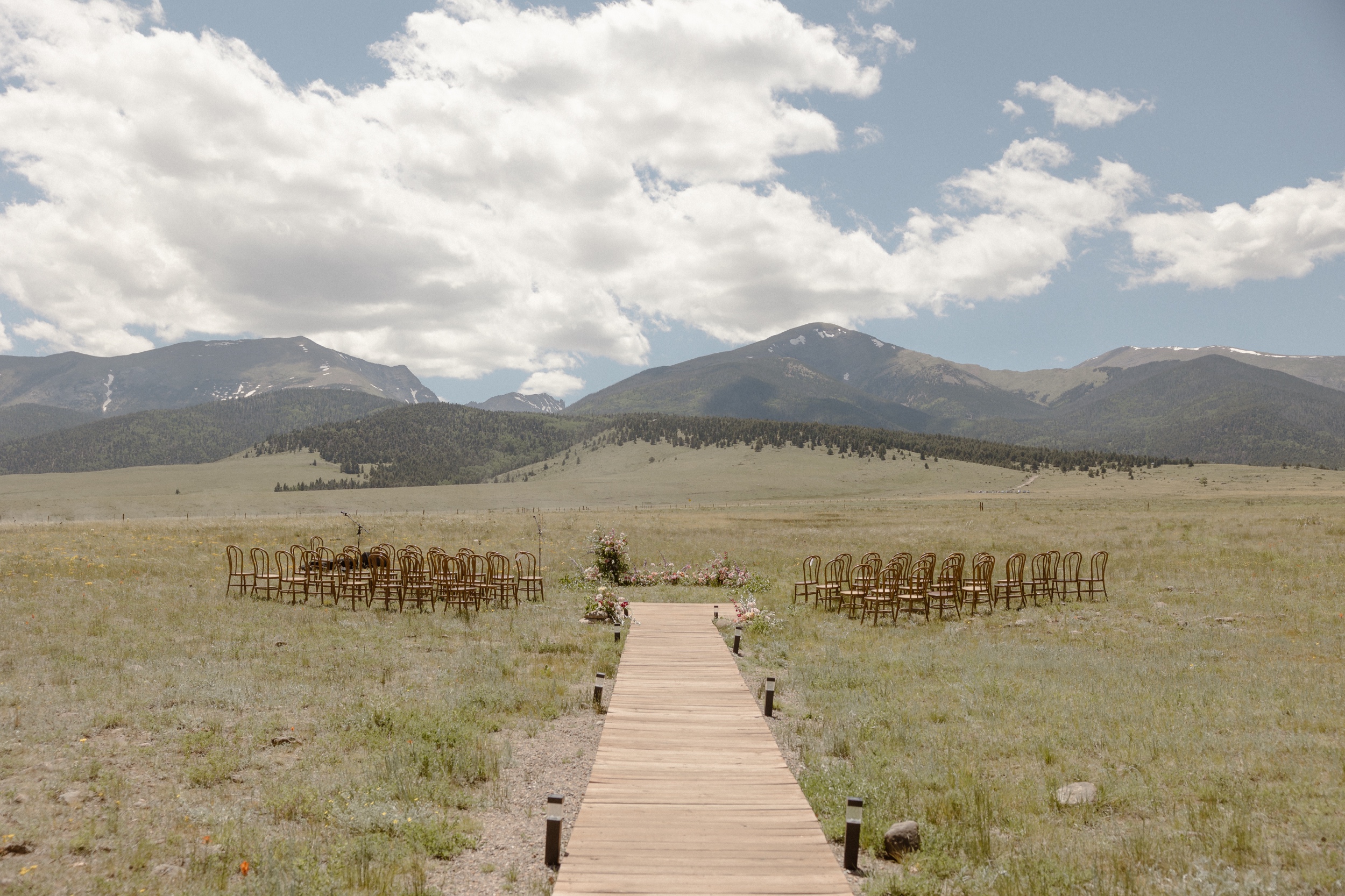 A wide photo of an empty ceremony setup for a Three Peaks Ranch wedding. Photo by Ashley Joyce.