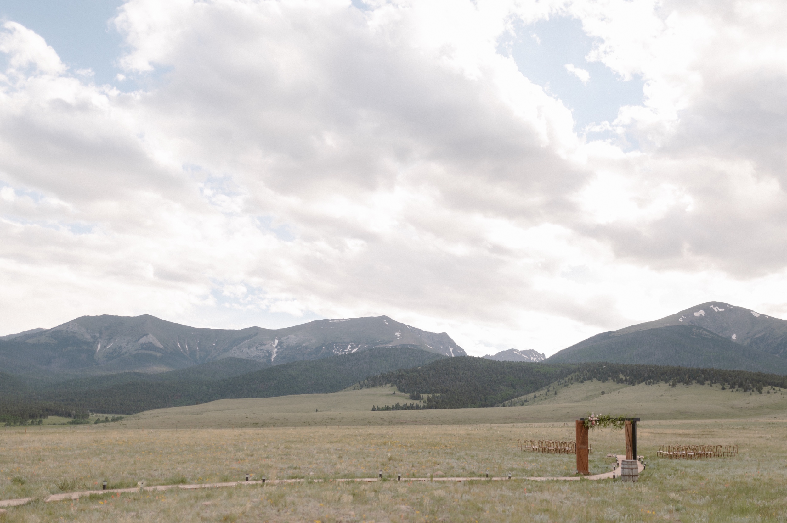 A wide shot of a ceremony site setup at Three Peaks Ranch. Photo by Ashley Joyce.